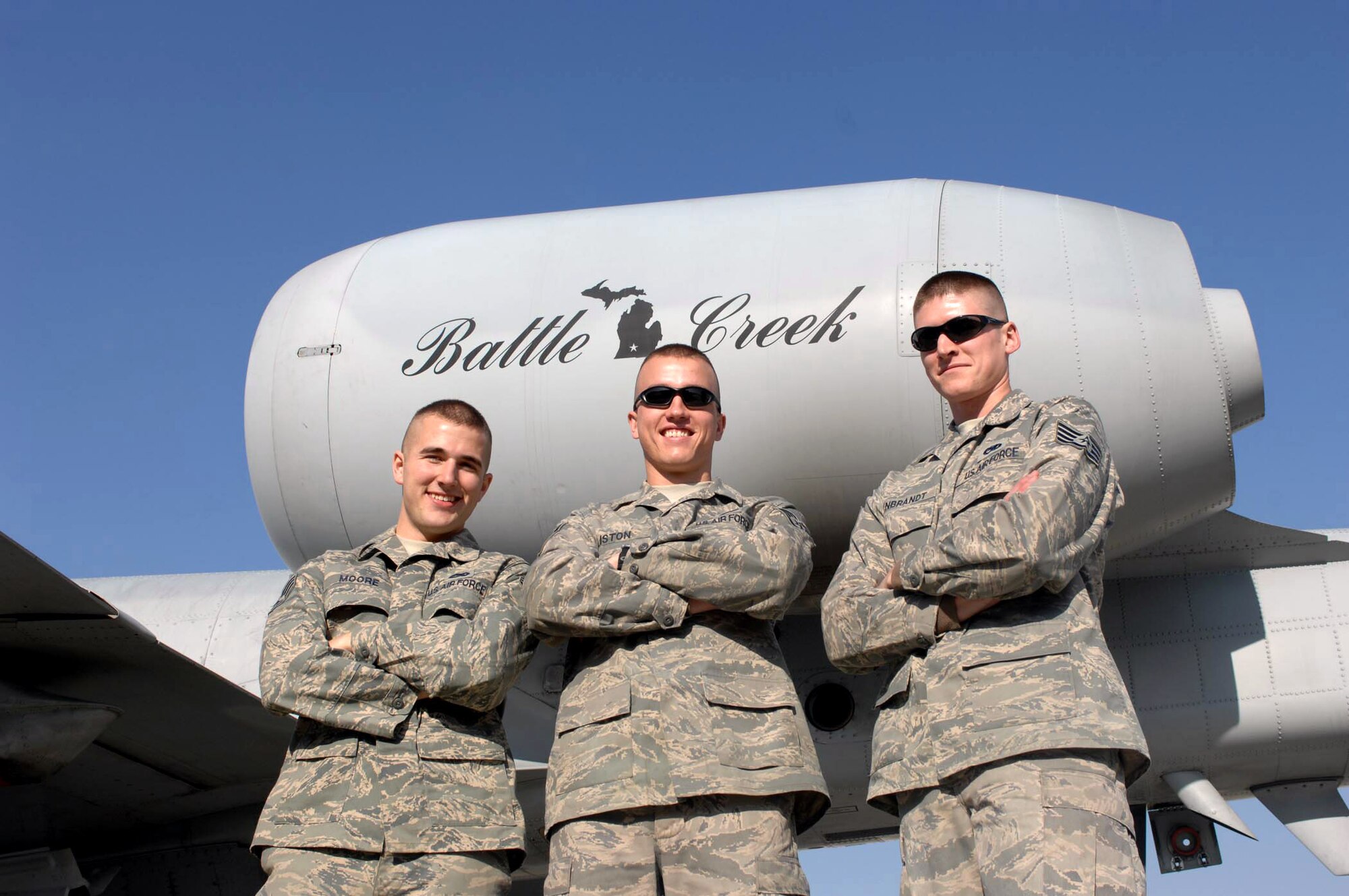 (Left to right) Staff Sergeants Bryce Moore, James Liston and Kevin Rynbrandt stand in front of one of their unit's jets Jan. 1 at Bagram Air Base, Afghanistan. All three were recently notified that they had been selected for pilot training. The Airmen are deployed from the 110th Fighter Wing, at Battle Creek, Mich. (U.S. Air Force photo/Staff Sgt. Mike Andriacco) 