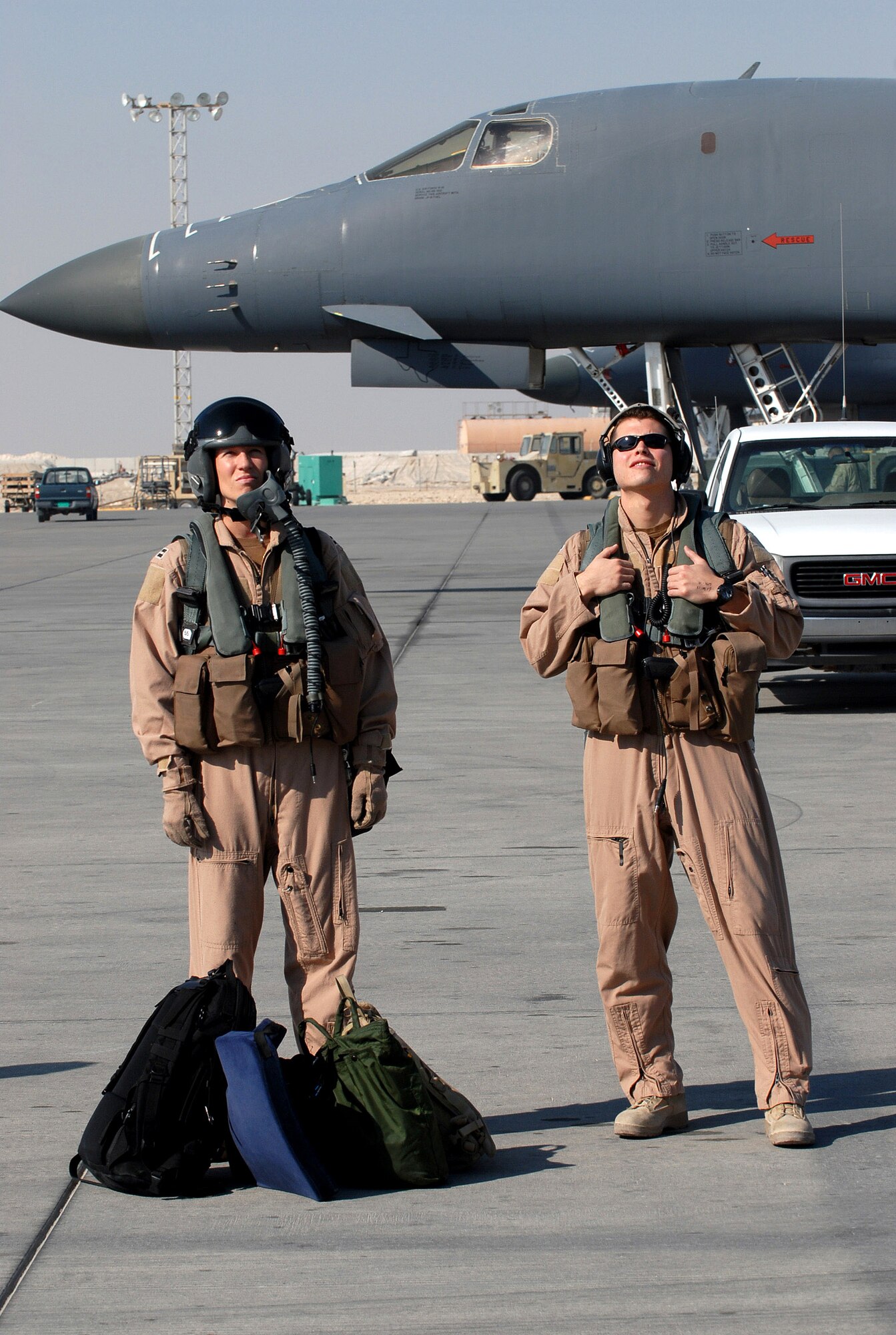 Capt.Crystal Powers (left) and 1st Lt. Thomas Walsh wait to board a B-1B Lancer bomber for a mission Dec. 29.  Captain Powers and Lieutenant Walsh are with the 9th Expeditionary Bomb Squadron at an air base in Southwest Asia. (U. S. Air Force photo/Staff Sgt. Douglas Olsen)
