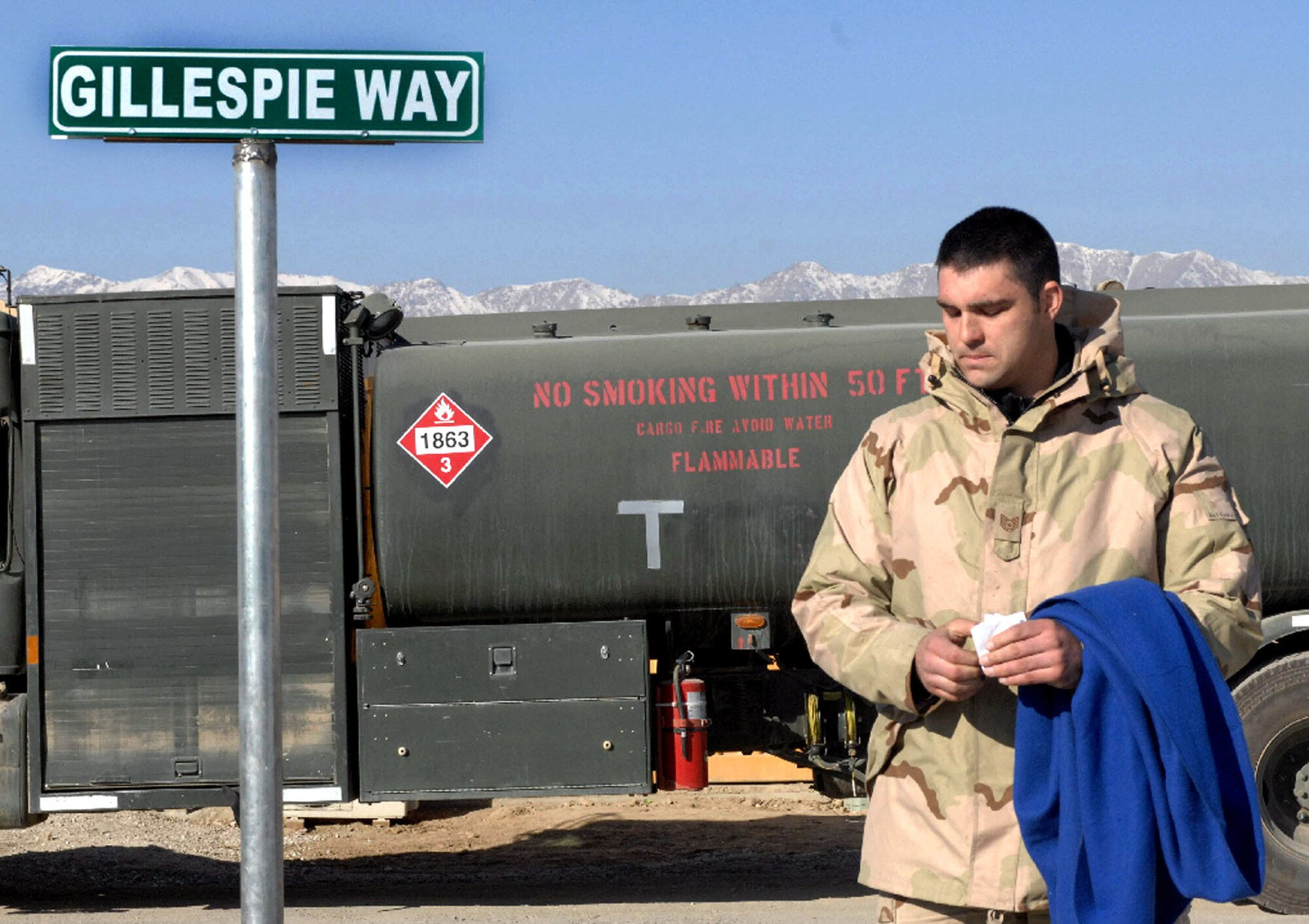 Tech. Sgt. Blaine Arsenault pauses for a moment of silence Dec. 1after unveiling a sign dedicating a road near the fuel farm at Bagram Air Base, Afghanistan, to the memory of fallen Airmen Master Sgt. Randy Gillespie. Sergeant Gillespie was Sergeant Arsenault's first supervisor and a career fuels specialist who died July 9 from wounds sustained during small arms fire near Herat, Afghanistan. Sergeant Arsenault is a career fuels specialist with the 455th Expeditionary Logistics Readiness Squadron. (U.S. Air Force photo/Capt. Michael Meridith)