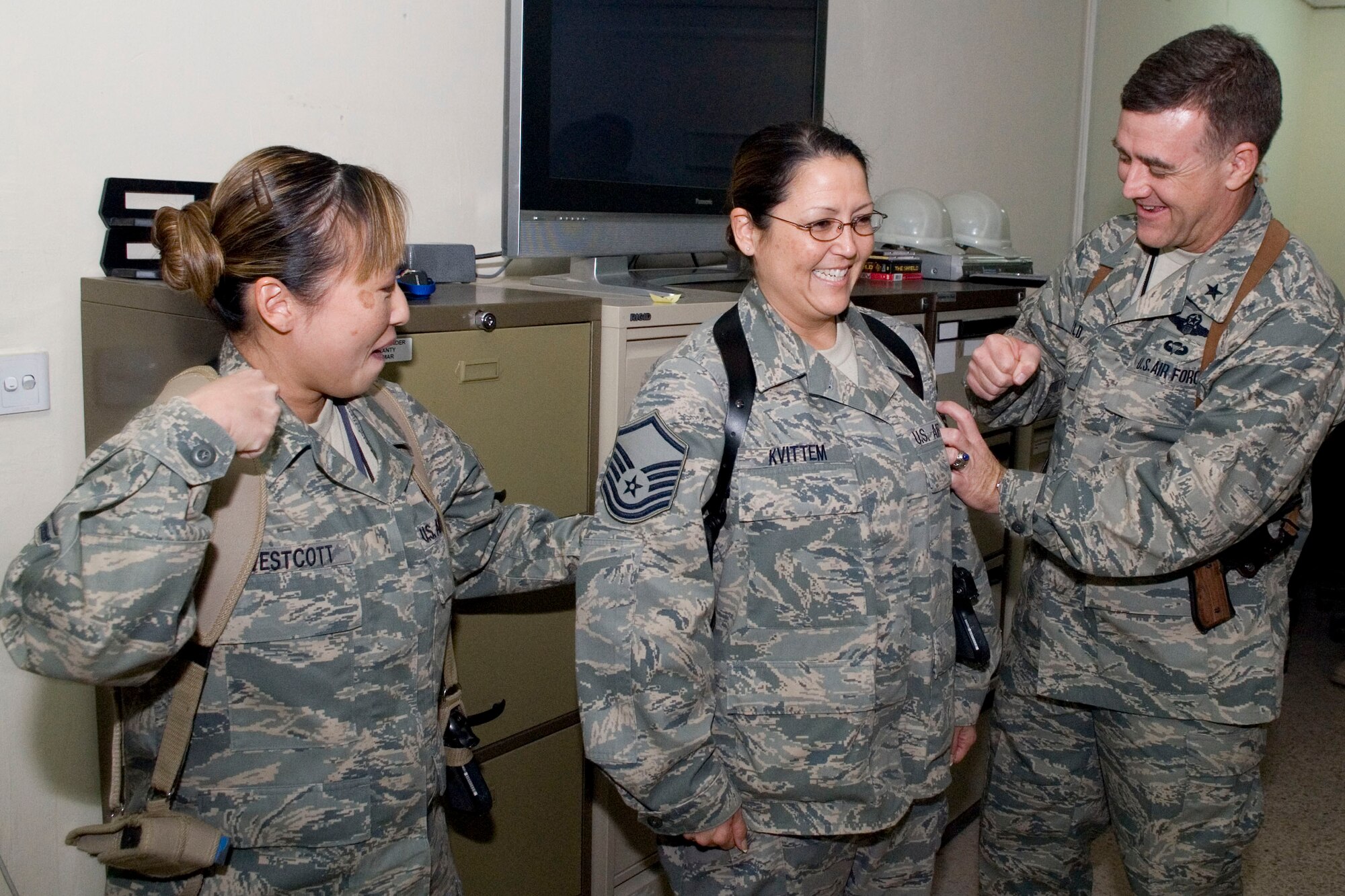 BALAD AIR BASE, Iraq -- Tech. Sgt. Brenda Kvittem, Regional Contracting Center – Balad, is notified of her stripes for exceptional performance promotion to master sergeant by Brig. Gen. Burt Field, 332nd Air Expeditionary Wing Commander, here, Jan. 3.  Master Sgt. Leslie Westcott, also from the RCC-Balad joins the general in tacking on the new stripes. Sergeant Kvittem’s STEP promotion to Master Sgt. was effective Jan. 2. Sergeant Kvittem is deployed from Eielson Air Force Base, Alaska.  (U.S. Air Force photo/Staff Sgt. Joshua Garcia) 