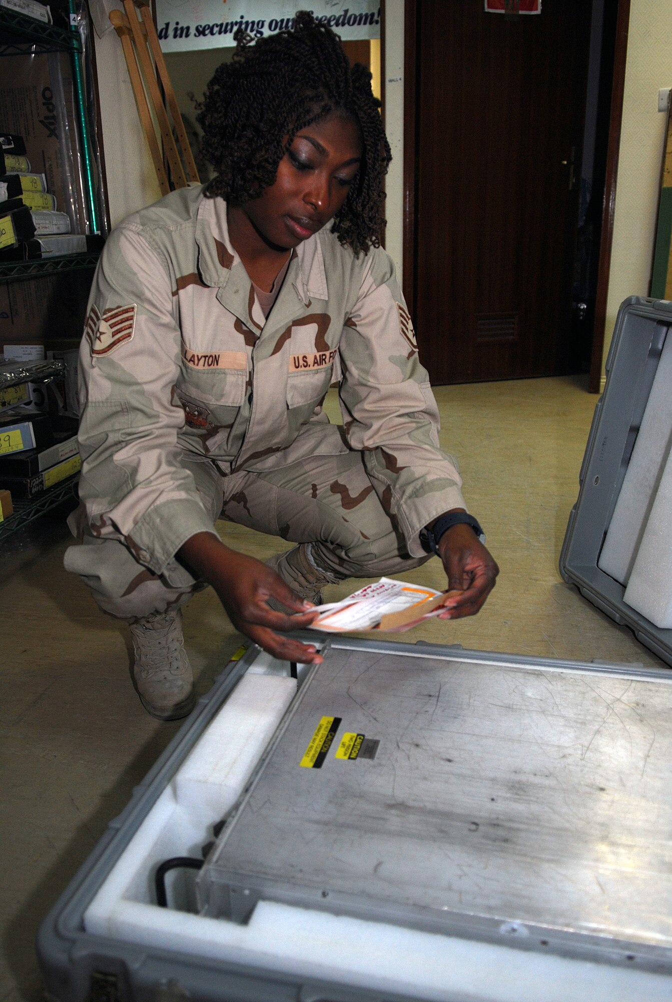 SOUTHWEST ASIA - Staff Sgt. Carmeisha Layton, NCOIC of satellite supplies for the 736rd Expeditionary Reconnaissance Squadron, examines documentation for stocked items under her control at a Southwest Asia air base Jan. 3. Sergeant Layton ensures the supplies and material necessary to repair and maintain the RC-135 Rivet Joint aircraft are in place to keep the 763 ERS mission running smoothly. The 763 ERS is a tenant unit of the 379th Air Expeditionary Wing. She is deployed from Kadena Air Force Base, Japan. (U. S. Air Force photo/Staff Sgt. Douglas Olsen)