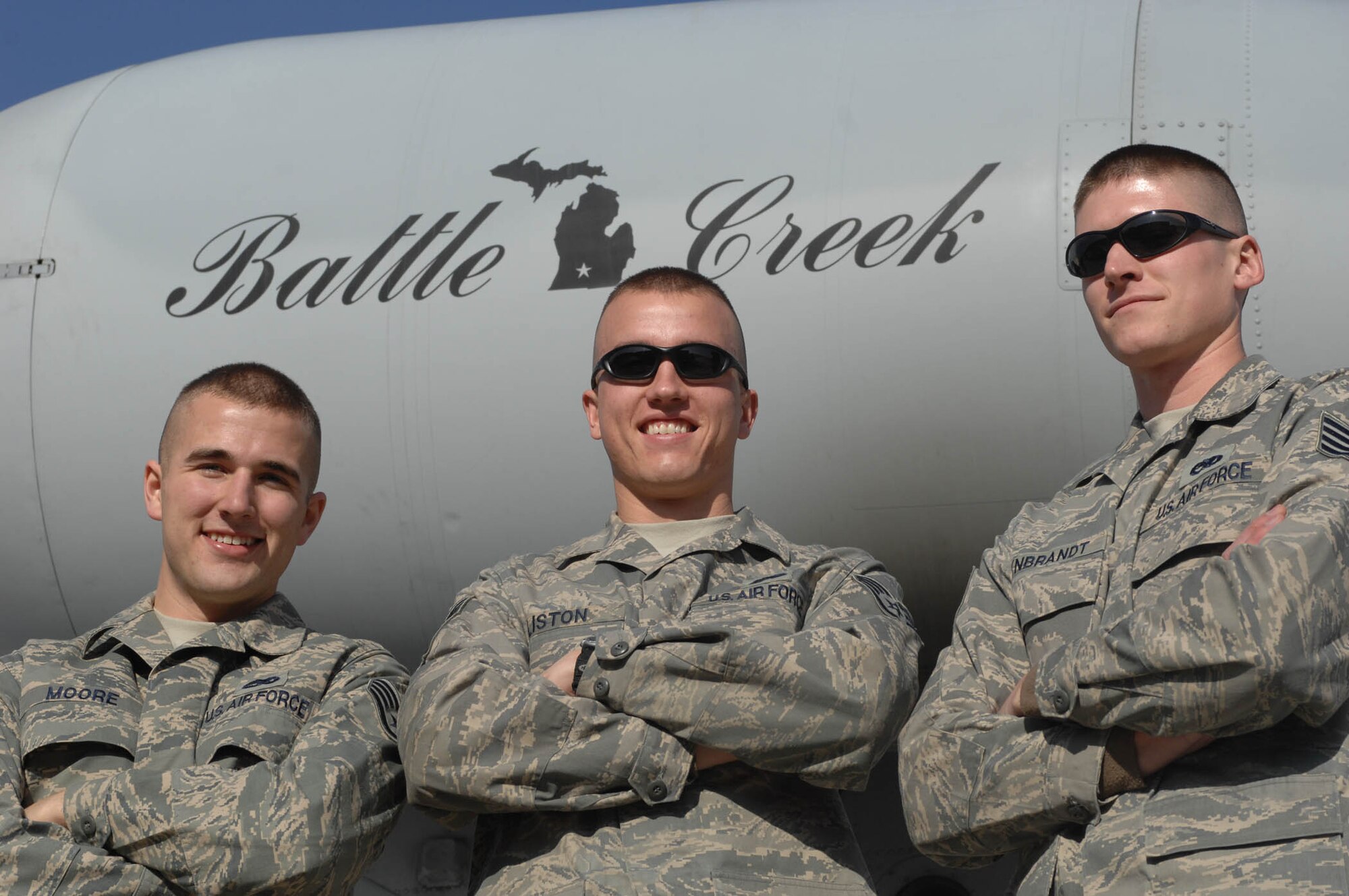 BAGRAM AIR BASE, Afghanistan -- (from left to right) Staff Sergeants Bryce Moore, James Liston and Kevin Rynbrandt deployed here from the 110th Fighter Wing, Battle Creek, Mich., stand in front of one of their unit's jets.  All three were recently notified that they had been selected for active duty pilot training. (U.S. Air Force photo by Staff Sgt. Mike Andriacco) 
