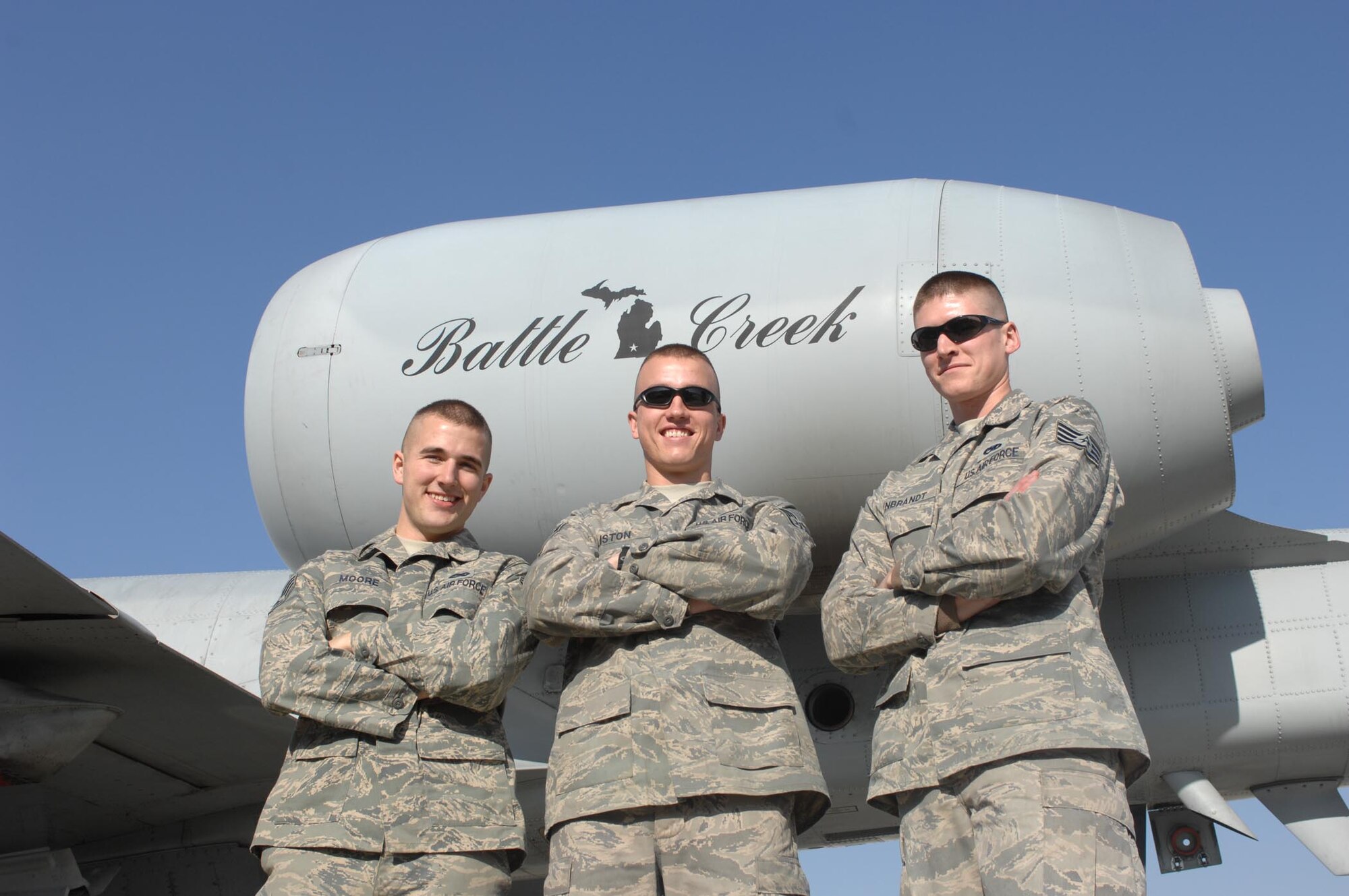 BAGRAM AIR BASE, Afghanistan -- (from left to right) Staff Sergeants Bryce Moore, James Liston and Kevin Rynbrandt deployed here from the 110th Fighter Wing, Battle Creek, Mich., stand in front of one of their unit's jets.  All three were recently notified that they had been selected for active duty pilot training. (U.S. Air Force photo by Staff Sgt. Mike Andriacco) 
