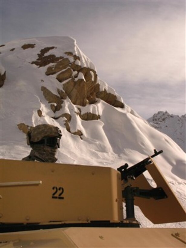 U.S. Army Spc. Nicholas Barron surveys the snowy landscape from his Humvee turret as he provides security during a Bagram Provincial Reconstruction Team assessment near the Salang Tunnel in the Parwan province of Afghanistan on Dec. 22, 2007.  
