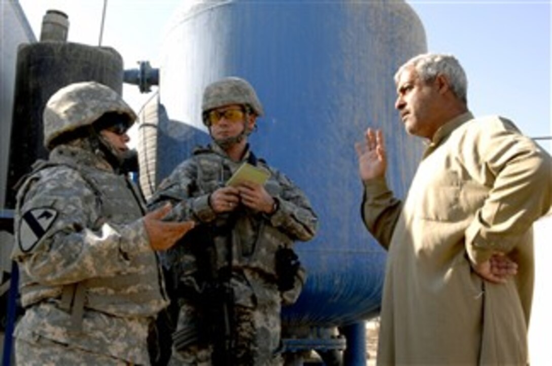 The owner of a water pump station discusses clean water supply problems with U.S. Army Maj. Ed Bowdish during a public service assessment in Al Raoud, Iraq, Dec. 27, 2007. Bowdish is assigned to the 492nd Civil Affairs Battalion, which is attached to the 1st Brigade Combat Team, 1st Cavalry Division. 
