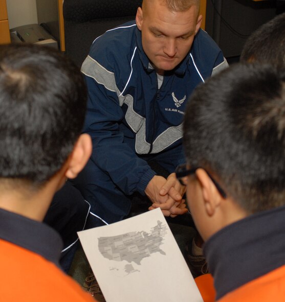 KUNSAN AIR BASE, South Korea --Tech Sgt. Richard Degrand, 8th Security Forces Squadron, show Korean soldiers a map of the United States Jan. 5 here. The meeting between members of the Wolf Pack and Republic of Korea Soldiers highlights the relationship between two ally nations. (U.S. Air Force photo/Senior Airman Giang Nguyen)