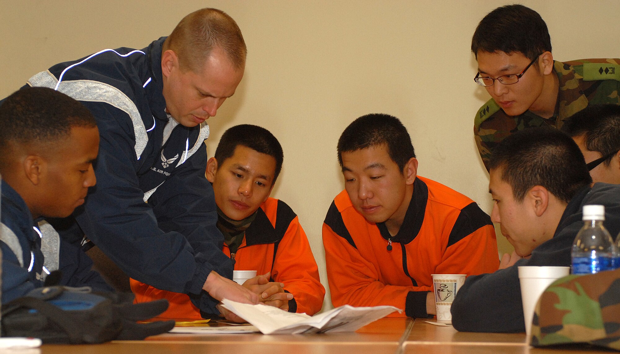KUNSAN AIR BASE, South Korea -- Master Sgt. William Seguin and Staff Sgt. Christopher Manning, 8th Security Forces Squadron, show Korean soldiers a map of the United States Jan. 5 here. The meeting between members of the Wolf Pack and Republic of Korea Soldiers highlights the relationship between two ally nations. (U.S. Air Force photo/Senior Airman Giang Nguyen)