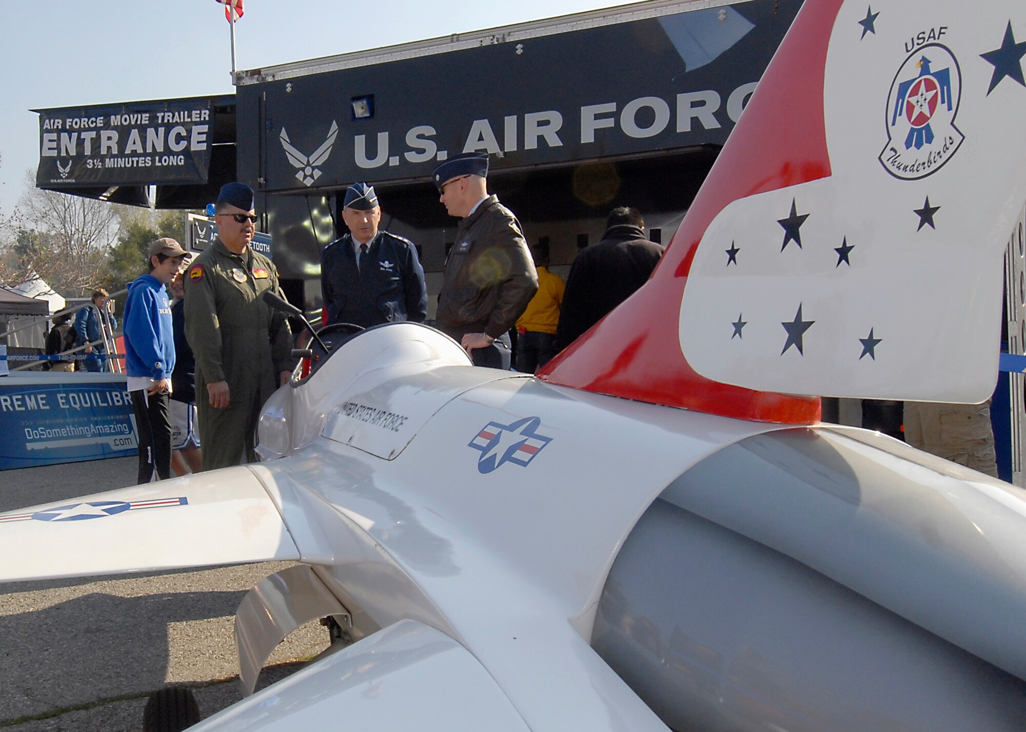Lt. Gen. Michael Hamel, Space and Missile Systems Center commander (center), chats with the crew of a miniature F-16 Thunderbird at the Air Force exhibit titled “Do something Amazing,” during the Pasadena Tournament of Roses Fanfest, Dec. 30.  Personnel from Los Angeles Air Force base helped man the exhibit during the event. (Photo by Joseph Juarez)