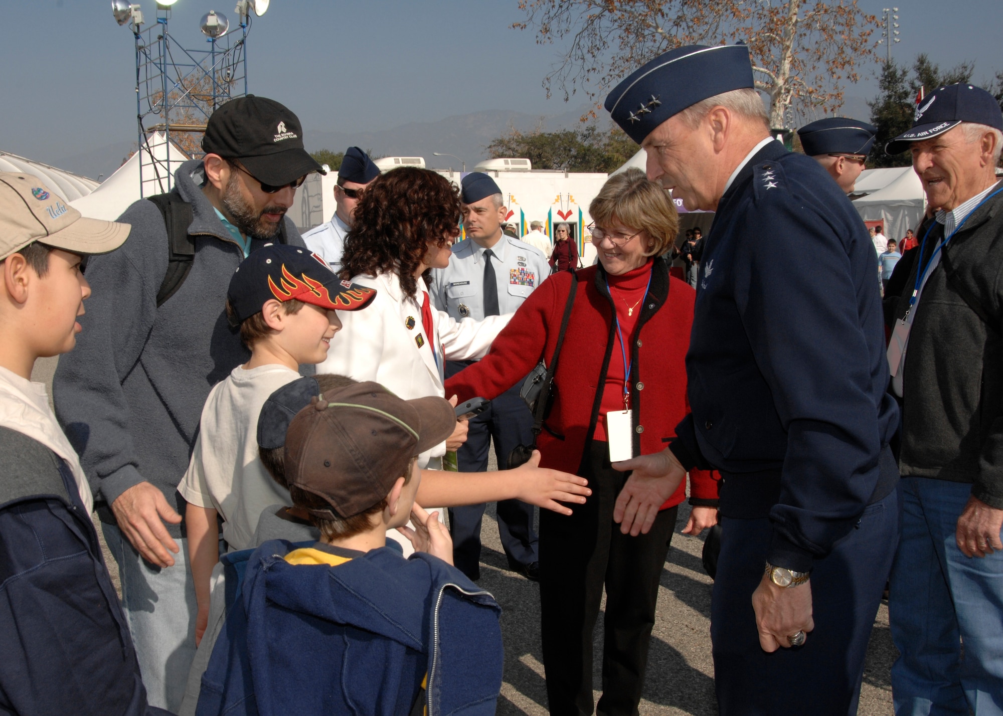 Lt. Gen. Michael Hamel, Space and Missile Systems Center commander, greets children attending the Fanfest, a pre-Tournament of Roses Parade event held at the Pasadena Rose Bowl stadium parking area, Dec. 30. (Photo by Joseph Juarez)