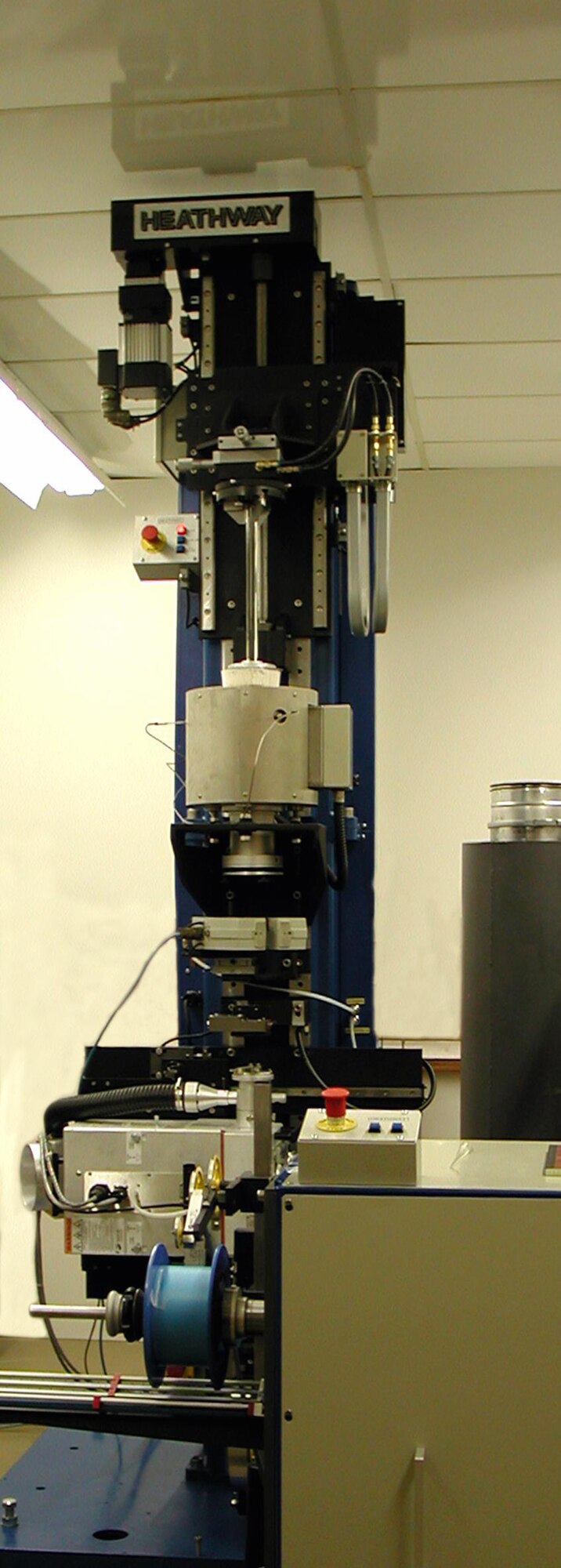 This glass fiber drawing tower can reduce the size of fibers from approximately one-half inch in diameter to smaller than a human hair. (Photo courtesy of J.V. Moloney)