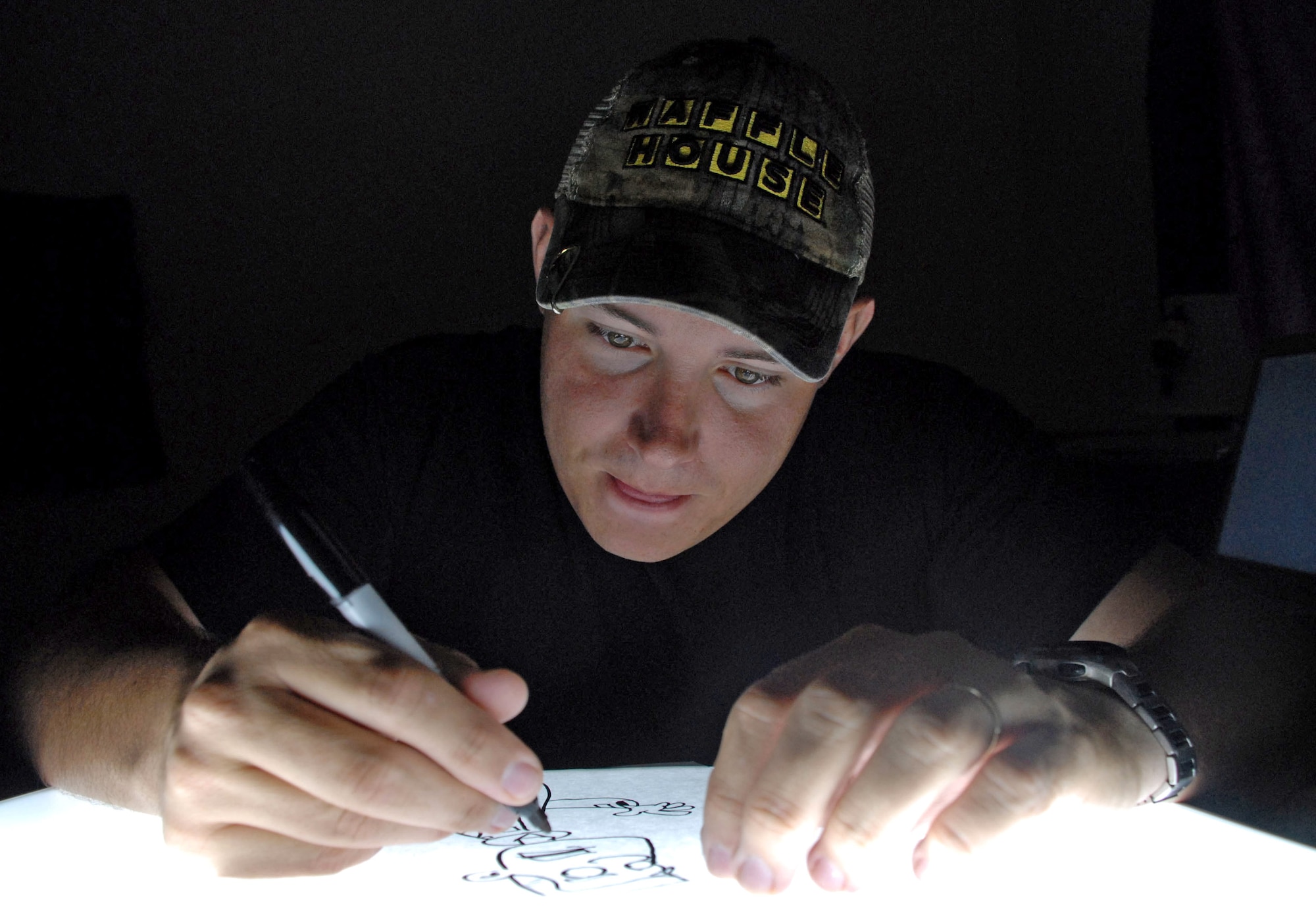 Staff Sgt. Austin M. May works on a character from his comic strip, Air Force Blues, Jan. 2 at Soto Cano Air Base, Honduras. Sergeant May recently published a book of his comics, and Air Force Blues is slated to appear in an upcoming issue of Airman Magazine. Sergeant May is a public affairs specialist deployed from Laughlin Air Force Base, Texas. (U.S. Air Force photo/Tech. Sgt. Sonny Cohrs) 