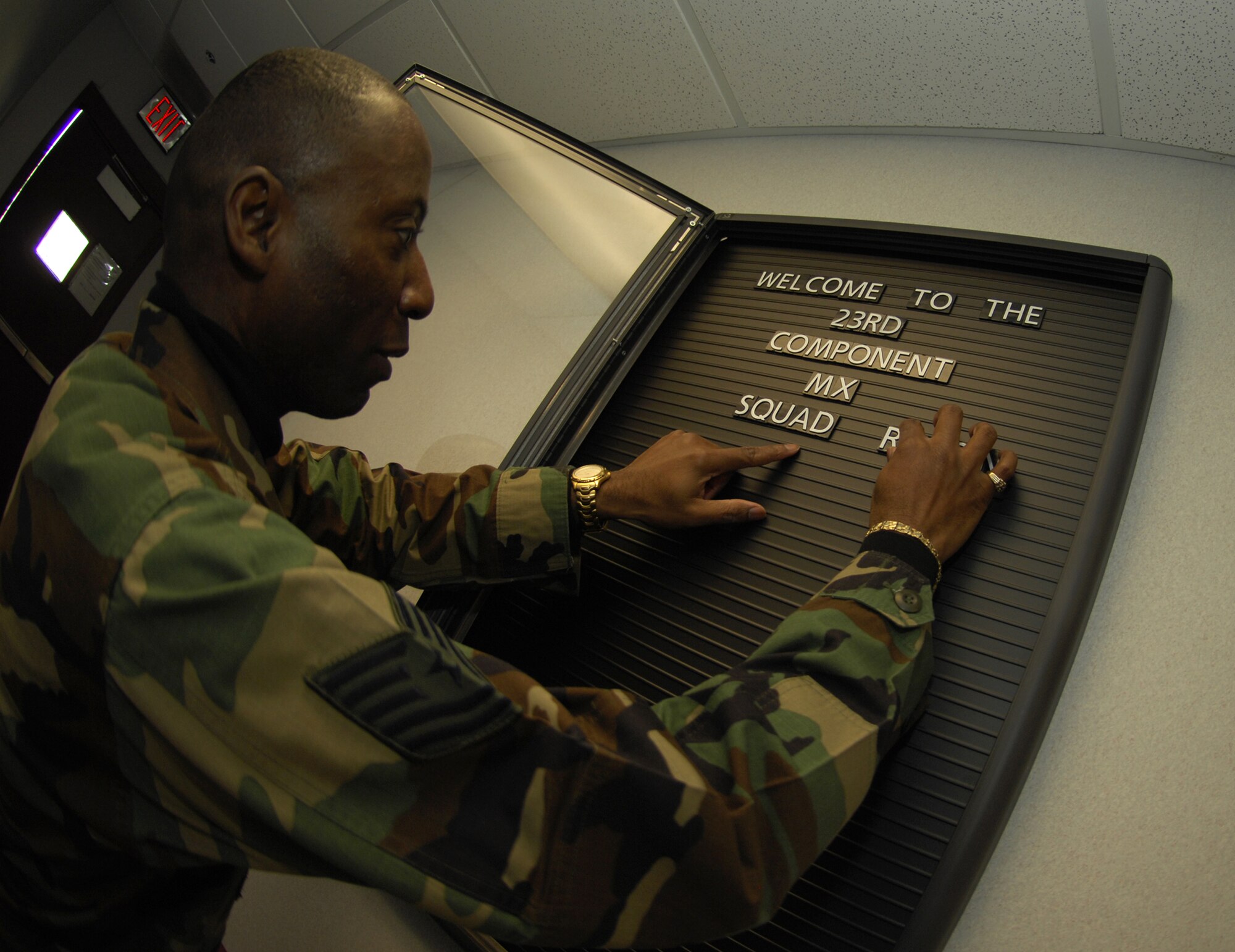 Tech. Sgt. Paul Reynolds, 23rd Component Maintenance Squadron technical administrator, puts up the 23rd CMS welcome sign at their command building Jan. 4.  The 23rd Maintenance Group recently stood-up the 23rd Equipment Maintenance Squadron and the 23rd CMS to provide better support to Moody aircraft.  (U.S. Air Force photo by Elizabeth Rissmiller)