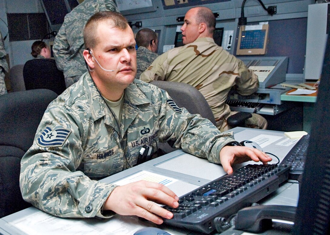 Tech. Sgt. Aaron Hawkes reads a new notice to Airmen at the combined en route radar approach control facility Balad Air Base, Iraq. Sergeant Hawkes is the 332nd Expeditionary Operations Support Squadron air traffic control watch supervisor deployed from Eglin Air Force Base, Fla. (U.S. Air Force photo/Senior Airman Travis Edwards) 
