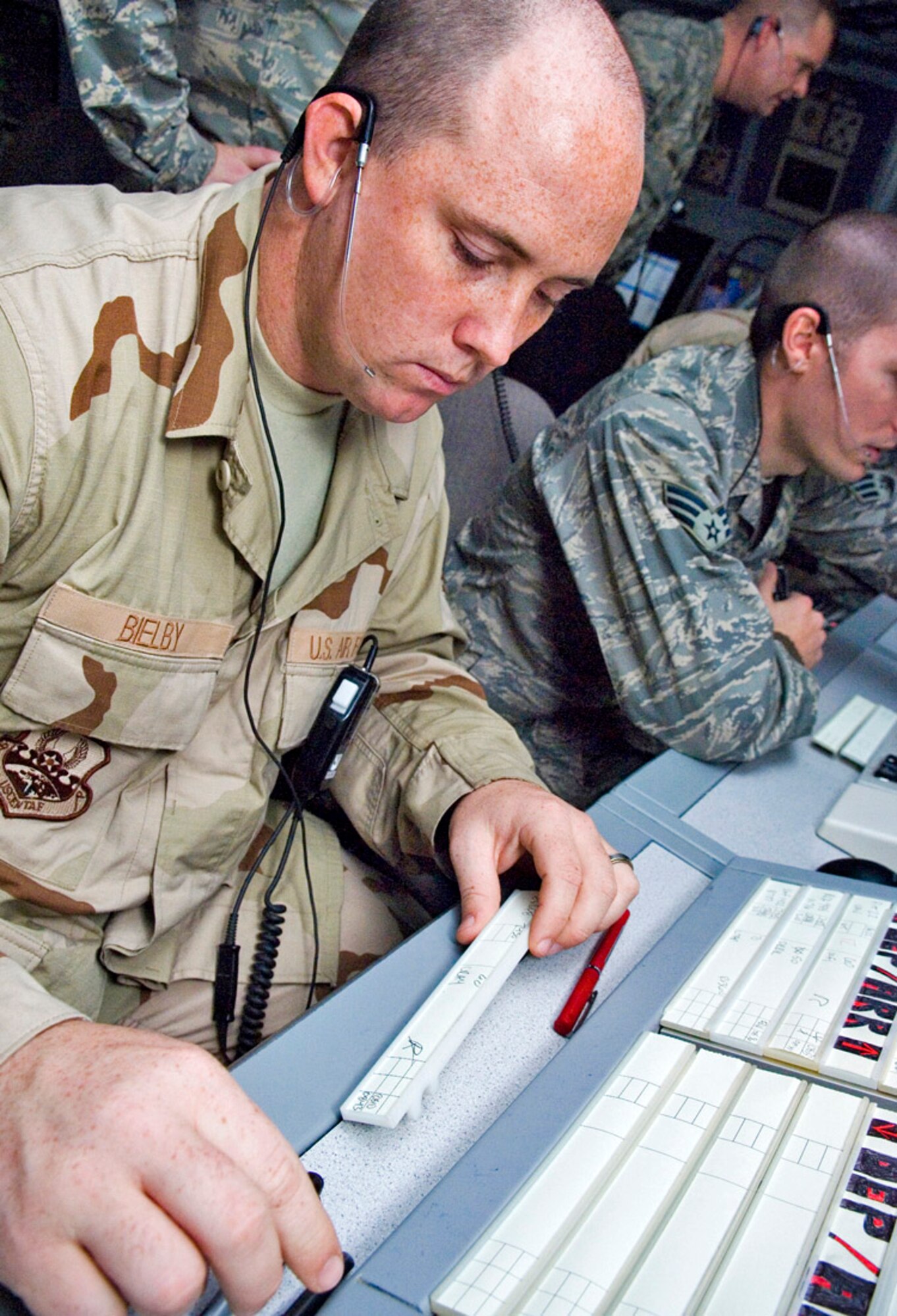 Senior Airman Bobby Bielby  works in the departure assistant position at Balad Air Base, Iraq. The assist position marks flight-data strips and coordinates aircraft movement with other facilities. Airman Bielby is a 332nd Expeditionary Operations Support Squadron air traffic controller deployed from Whiteman Air Force Base, Mo. (U.S. Air Force photo/Senior Airman Travis Edwards) 