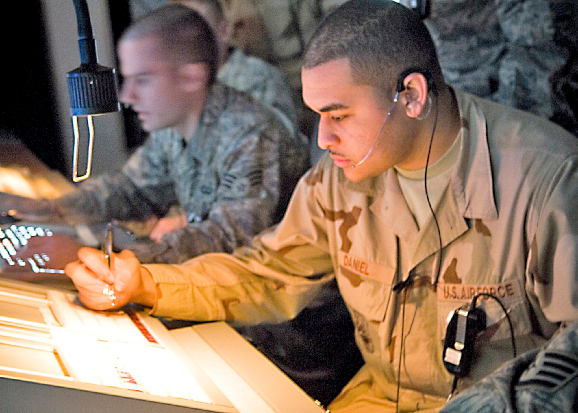 Senior Airman David Daniel works in the approach control assistant position at Balad Air Base, Iraq. The assist position marks flight-data strips and coordinates aircraft movement with adjacent facilities. Airman Daniel is a 332nd Expeditionary Operations Support Squadron air traffic controller and is deployed from Royal Air Force Lakenheath, England. (U.S. Air Force photo/Senior Airman Travis Edwards) 