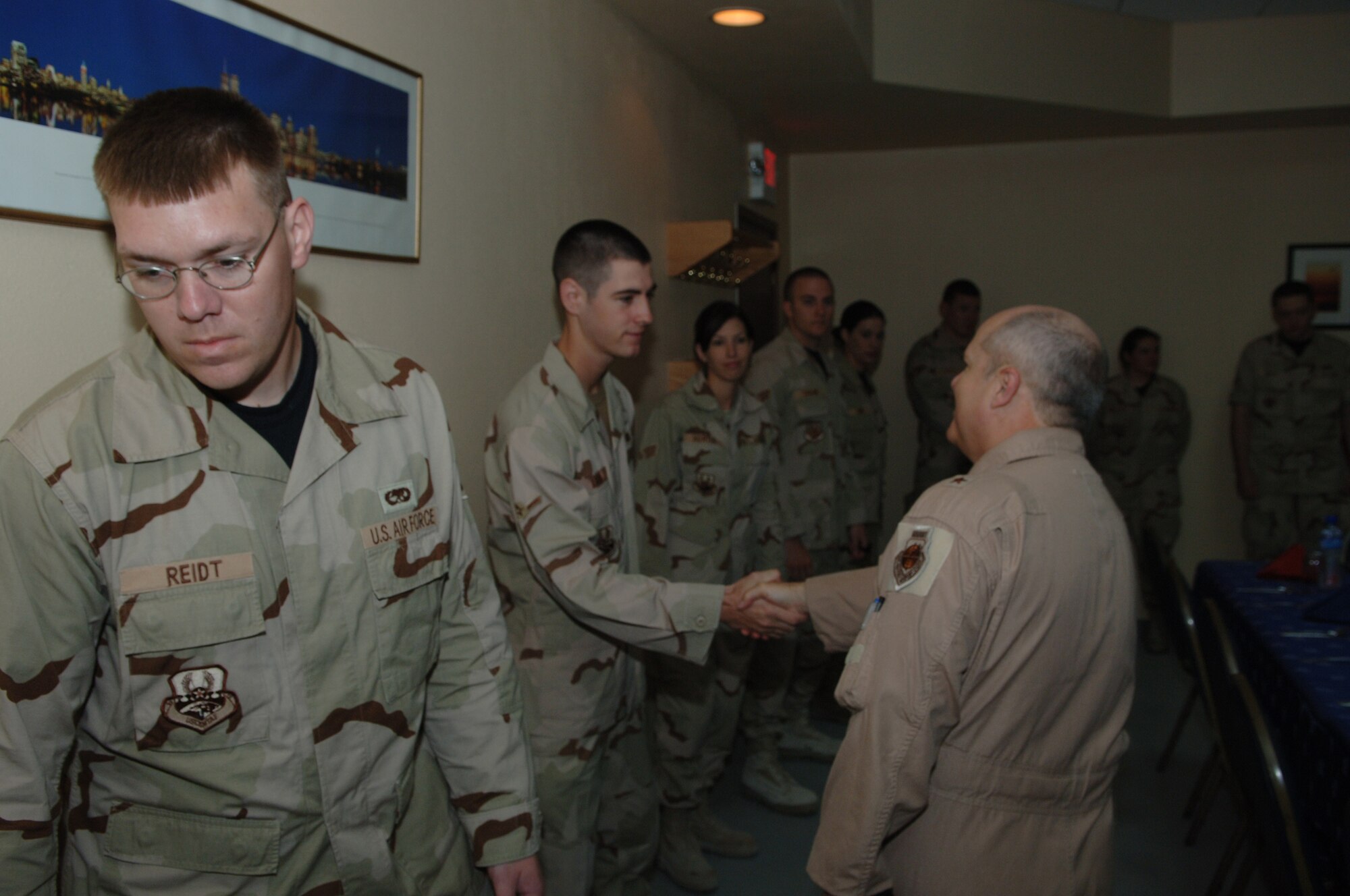 SOUTHWEST ASIA - Brig. Gen. Charlie Lyon, 379th Air Expeditionary Wing commander, meets and greets junior enlisted airmen Jan. 1 of the 379 AEW before he sits down to breakfast and address any concerns the airmen may have at a Southwest Asia air base. (U.S. Air Force photo/Master Sgt. Greg Kunkle)