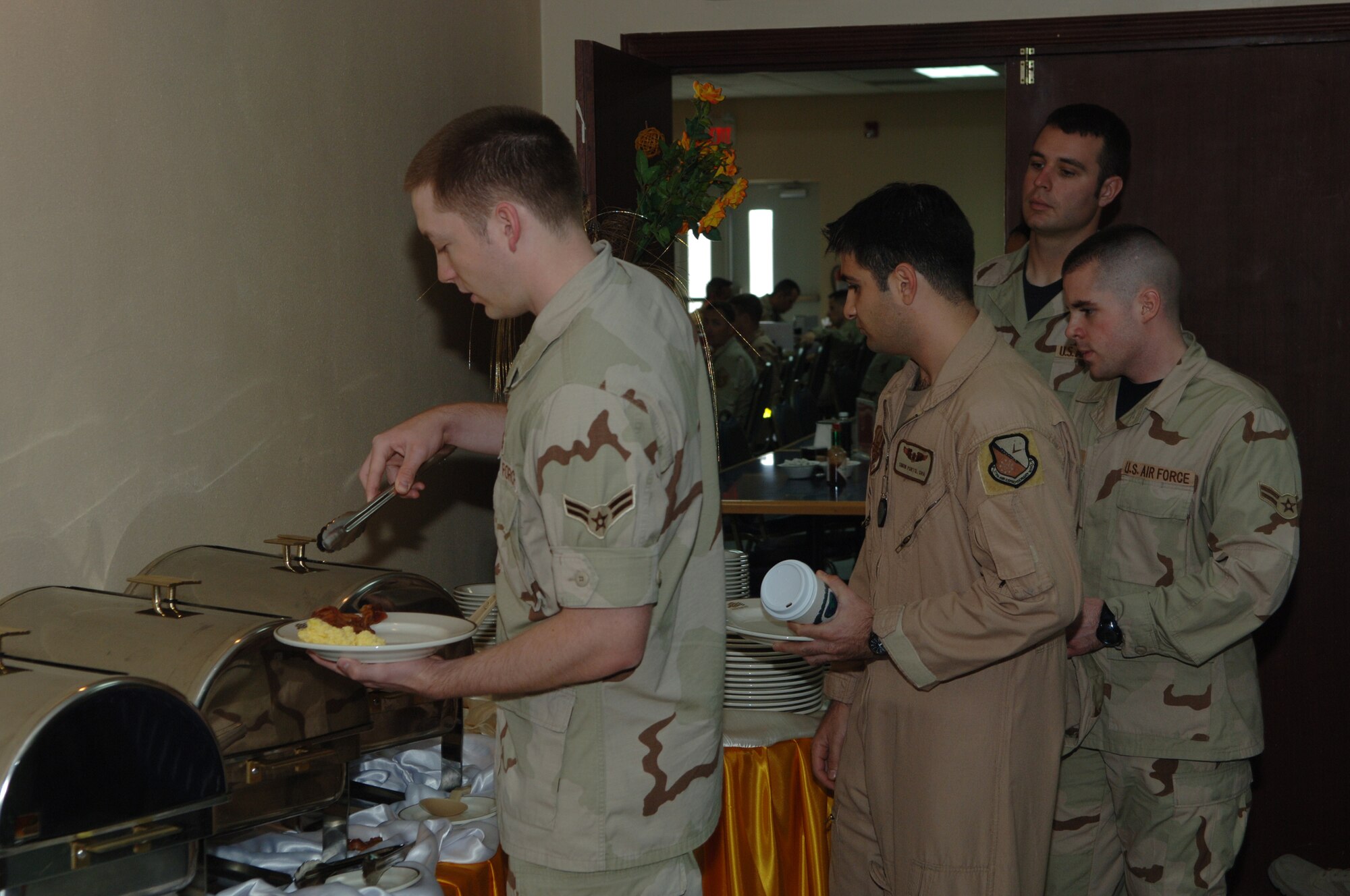 SOUTHWEST ASIA - Junior enlisted airmen of the 379th Air Expeditionary Wing line up for breakfast before sitting down with Brig. Gen. Charlie Lyon, 379th AEW commander. The general and Chief Master Sgt. Lloyd Hollen, 379th AEW command chief  met with airmen Jan. 1 to enjoy breakfast and address any concerns the airmen  may have at a Southwest Asia air base. (U.S. Air Force photo/Master Sgt. Greg Kunkle)


(Air Force Photo by Master Sergeant Greg Kunkle)