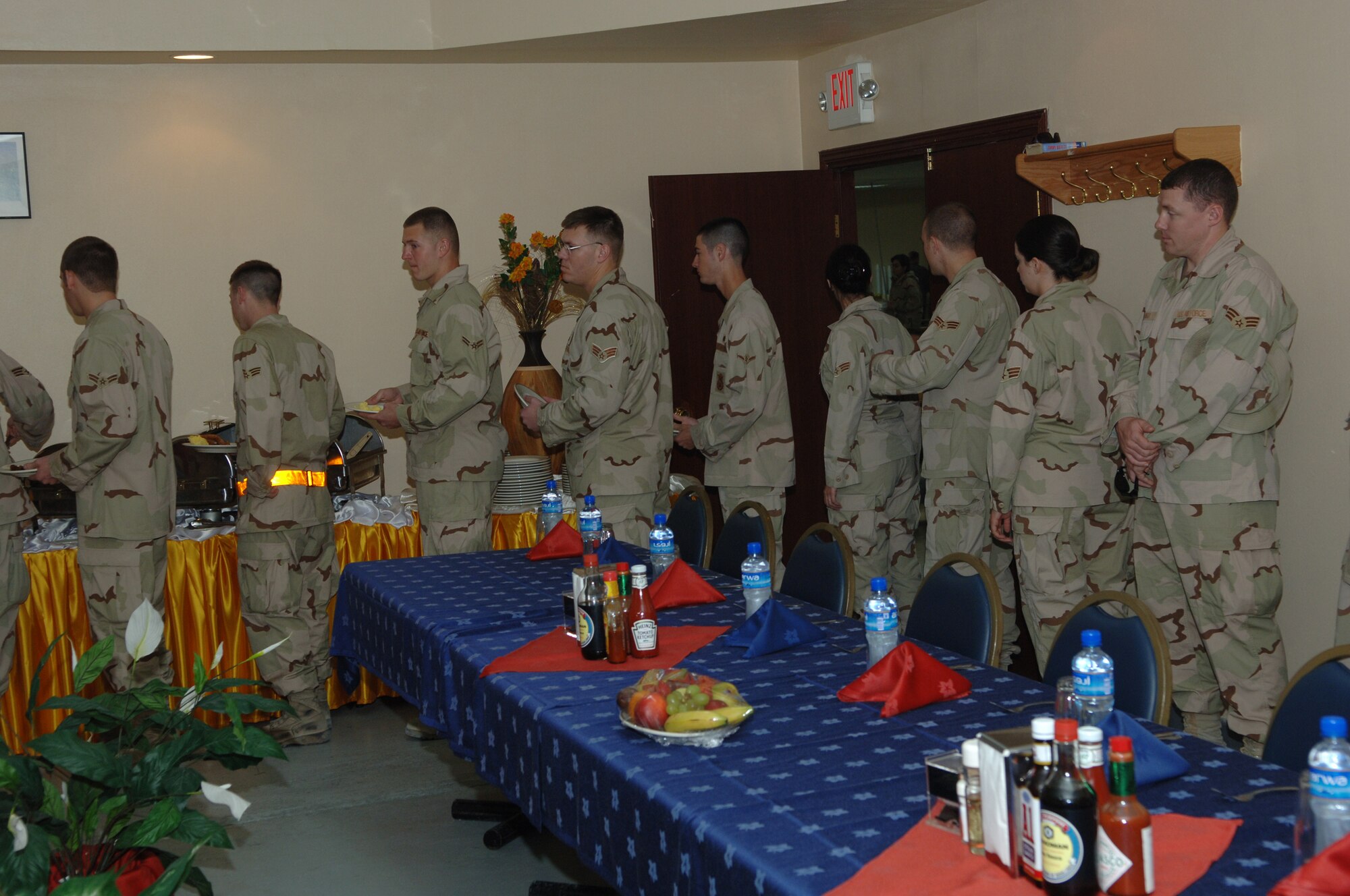 SOUTHWEST ASIA - Junior enlisted of the 379th Air Expeditionary Wing line up for breakfast before sitting down with Brig. Gen. Charlie Lyon, 379th AEW commander. The general and Chief Master Sgt. Lloyd Hollen, 379th AEW command chief  met with airmen Jan. 1 to enjoy breakfast and address any concerns the airmen  may have at a Southwest Asia air base. (U.S. Air Force photo/Master Sgt. Greg Kunkle)