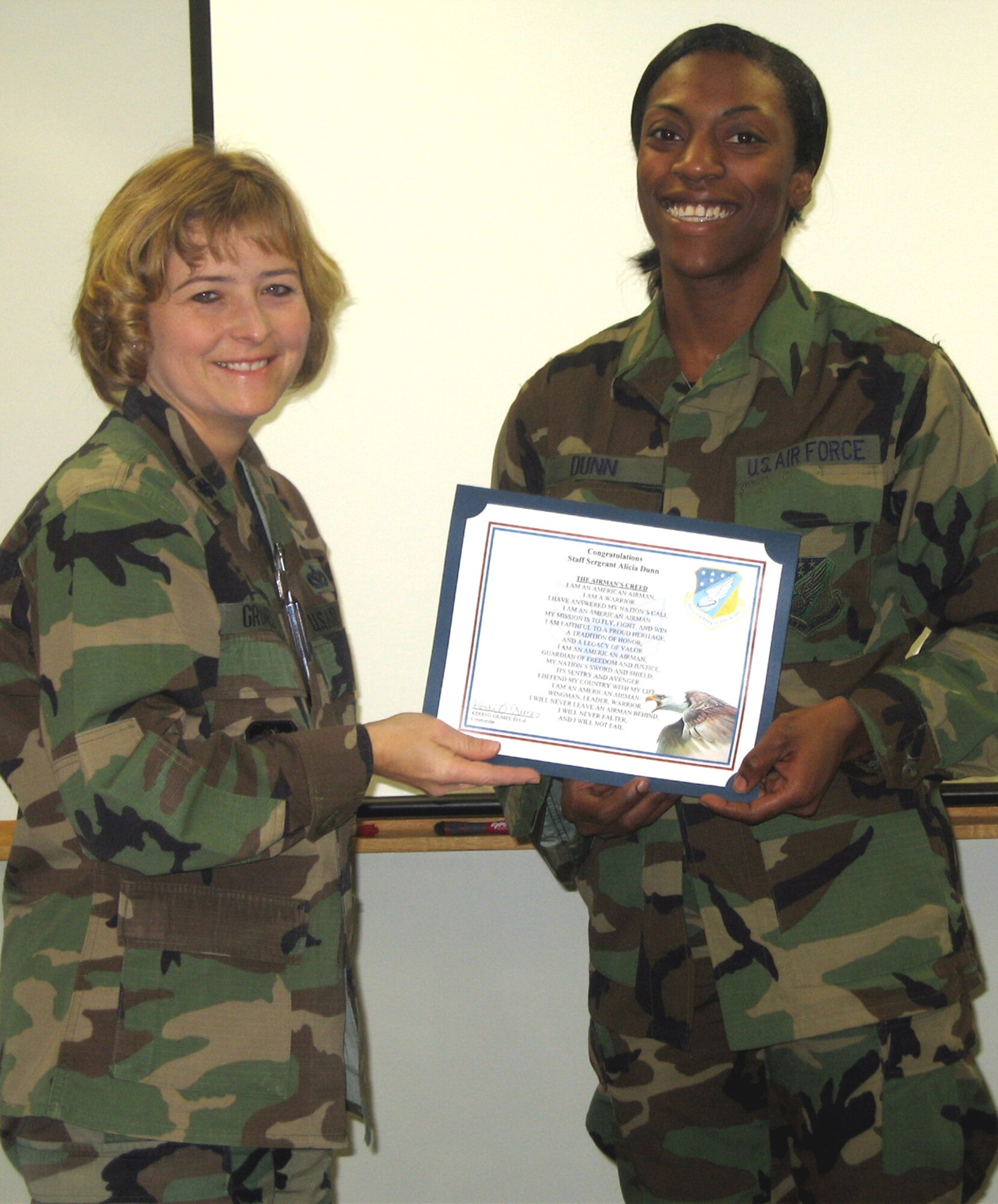 SEYMOUR JOHNSON AIR FORCE BASE, N.C. --Staff Sgt. Alicia Dunn (right), an engineering journeyman with the 916th Civil Engineer Squadron here, received her promotion certificate from Lt. Col. Kerri Grimes during the 916th Air Refueling Wing's Unit Training Assembly in December.

