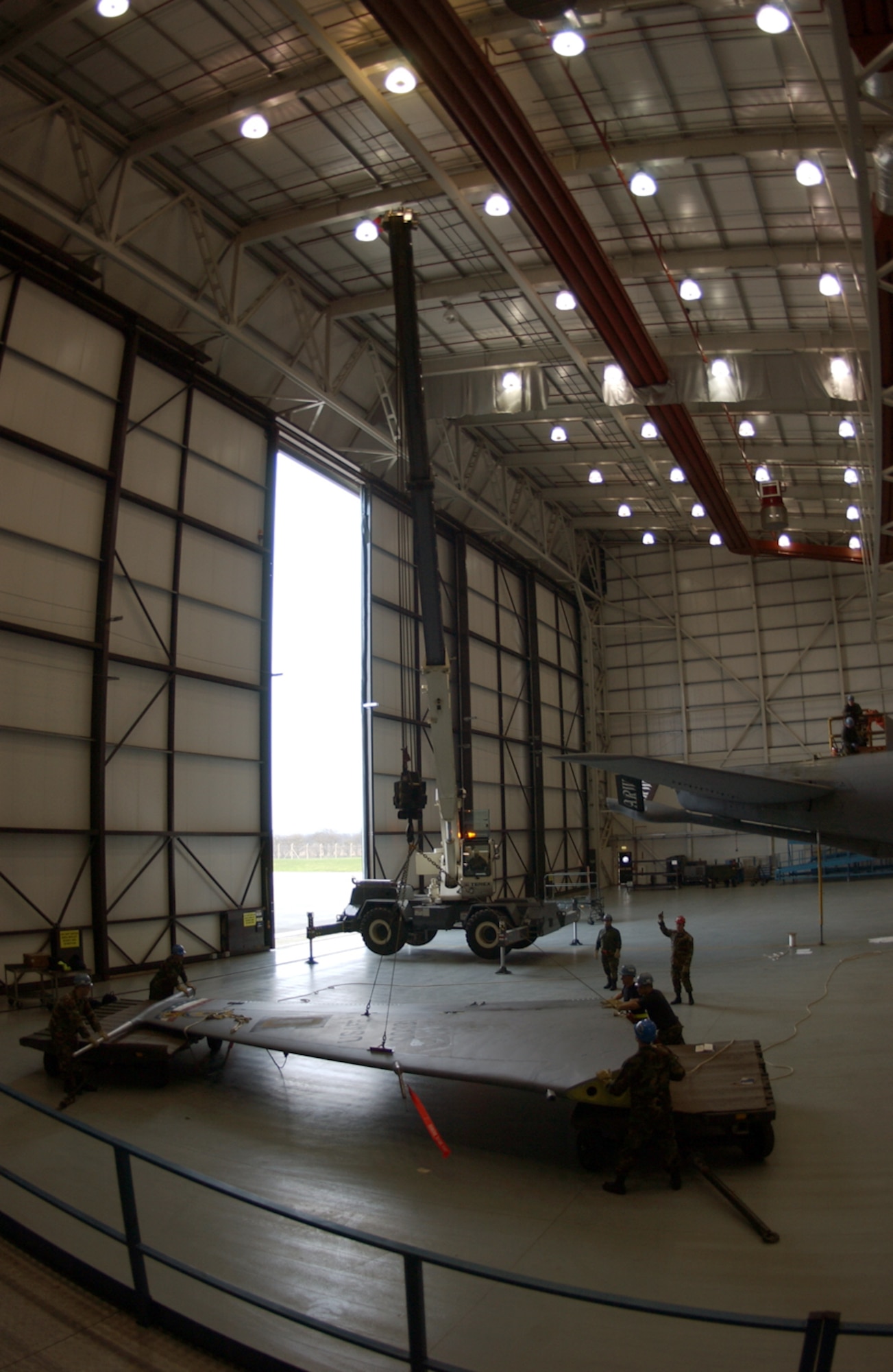 About a dozen Airmen with the 100th Maintenance Group helped remove and replace a vertical stabilizer on a KC-135 Stratotanker here Dec. 16. During a routine isochronal inspection, the vertical stabilizer was found to be corroded, warranting repairs. (U.S. Air Force photo/Senior Airman Clark Staehle)              