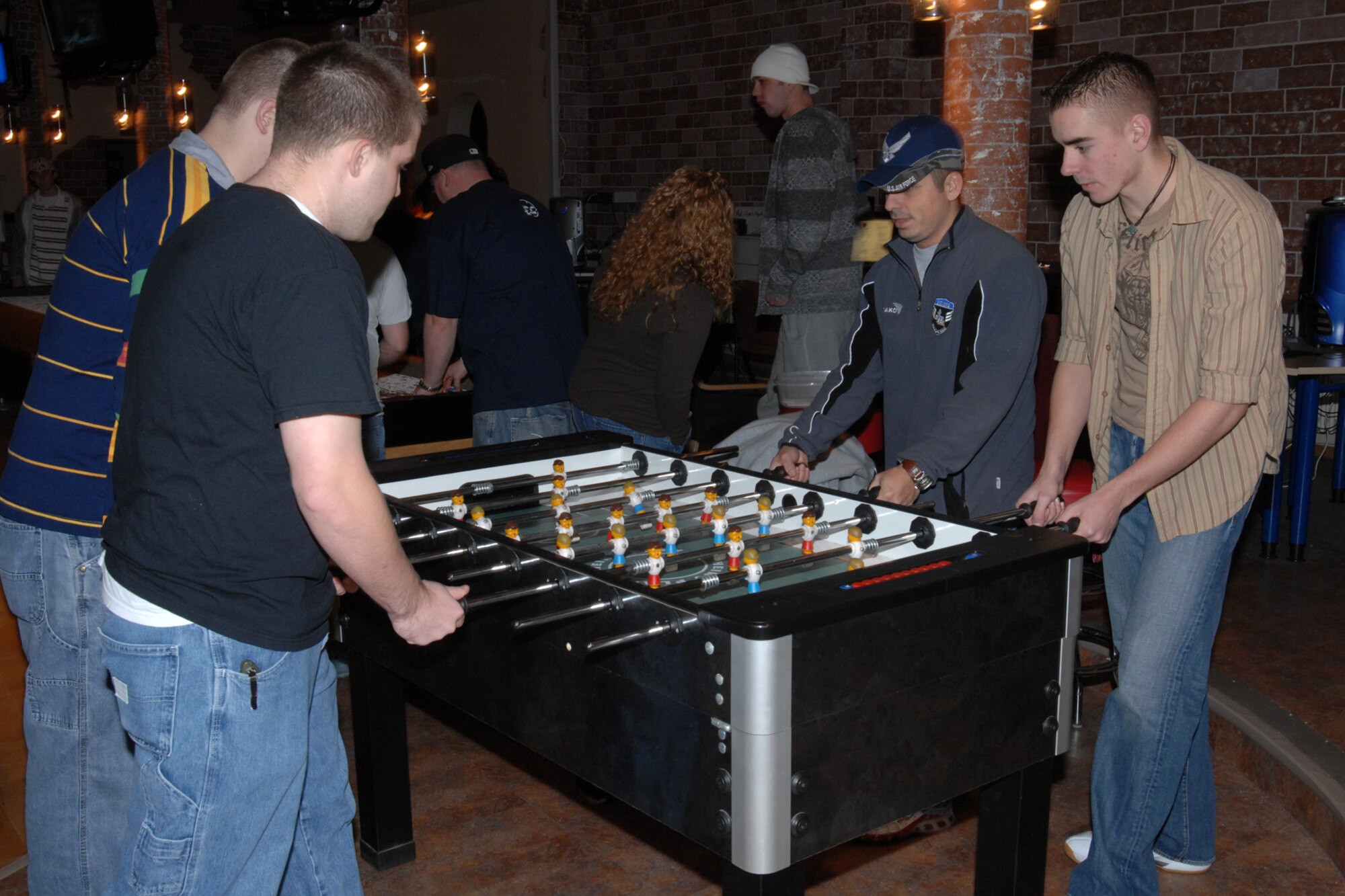 SPANGDAHLEM AIR BASE, Germany – Master Sgt. Michael Garcia, 606th Air Control Squadron first sergeant, plays foosball with various Airmen at the Unaccompanied Airman’s Holiday Party in the Brick House Dec. 22, 2007. The party was sponsored by the 52nd Fighter Wing First Sergeant’s Council. (U.S. Air Force photo/Airman 1st Class Jenifer Calhoun)