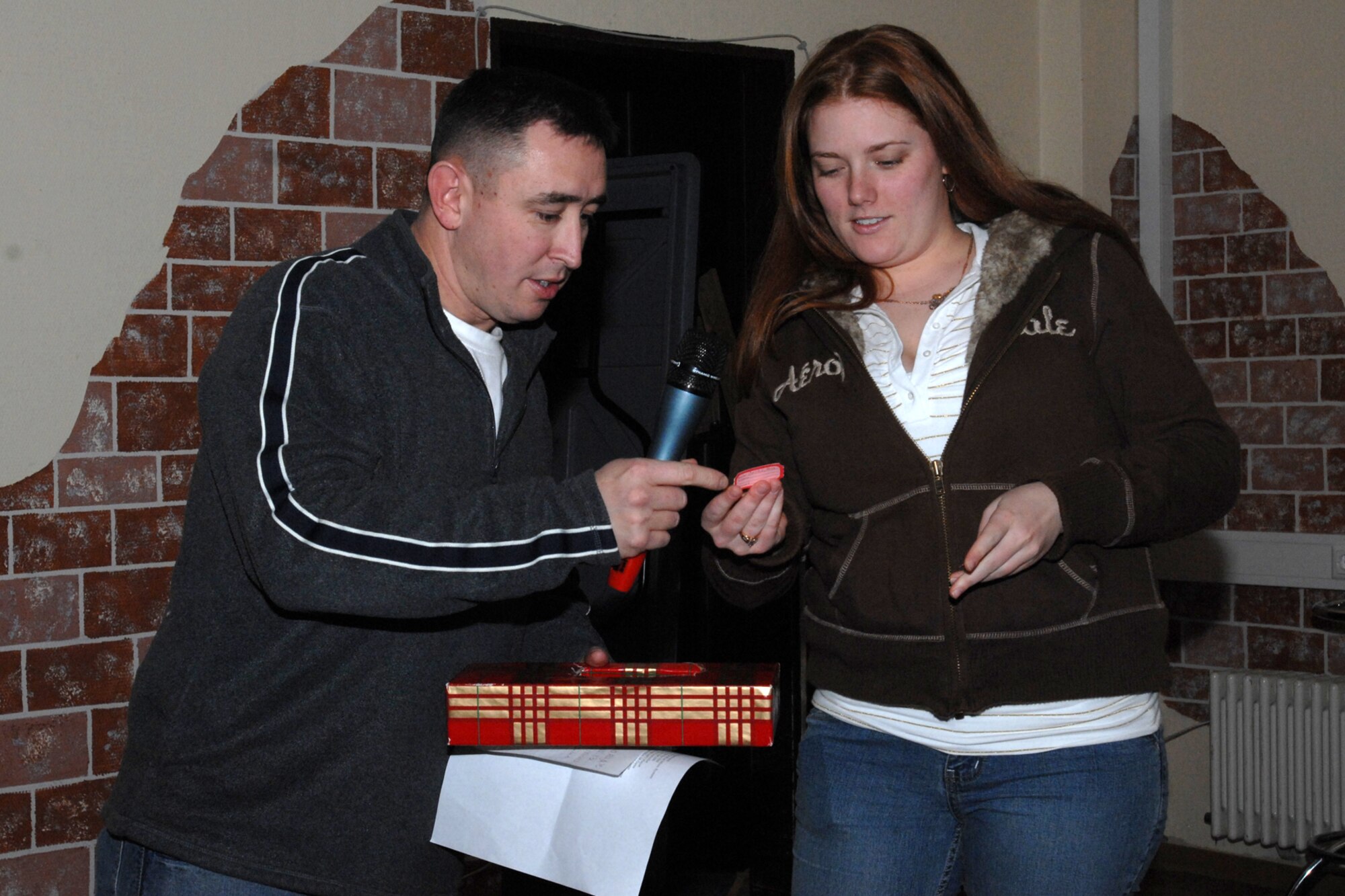 SPANGDAHLEM AIR BASE, Germany – Master Sgt. Jody Wray, 52nd Mission Support Squadron first sergeant, reads off a winner’s name as Airman 1st Class Erika Raymonds, 52nd MSS, hands him a ticket at the Unaccompanied Airman’s Holiday Party in the Brick House Dec. 22, 2007. The party sponsored by the 52nd Fighter Wing First Sergeant’s Council included a full holiday meal, door prizes and games. (U.S. Air Force photo/Airman 1st Class Jenifer Calhoun)