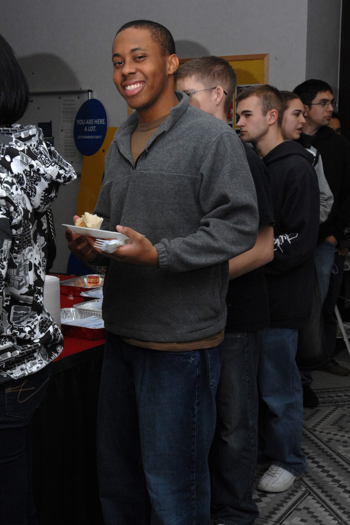 SPANGDAHLEM AIR BASE, Germany – Airman Adrian Paisley, 52nd Services Squadron, goes through the food line at the Unaccompanied Airman’s Holiday Party in the Brick House Dec. 22, 2007. The party sponsored by the 52nd Fighter Wing First Sergeant’s Council included a full holiday meal, door prizes and games. (U.S. Air Force photo/Airman 1st Class Jenifer Calhoun)