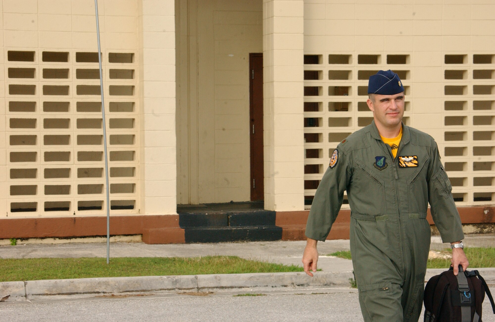 Maj. Ryan Link, 393rd Expeditionary Bomb Squadron assistant director of operations, carries some of his personal gear to the awaiting vehicle that will take him to the aircrew flight equipment section. There, Major Link will be issued his survival gear before he is taken to his pre-flighted jet. In this feature article, Major Link provides rarely seen insight of the many things it takes to run an operational flying squadron and in particular shares the contributions of the Airmen who comprise the aircrew flight equipment shop. (Air Force photo/Tech. Sgt. Steven Wilson)