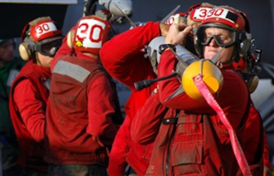 Aviation Ordnancemen attached to the "Raging Bulls" of Strike Fighter Squadron 37, unload ordnance off one of the squadron's aircraft during flight operations aboard the USS Harry S. Truman, Dec. 28, 2007. 