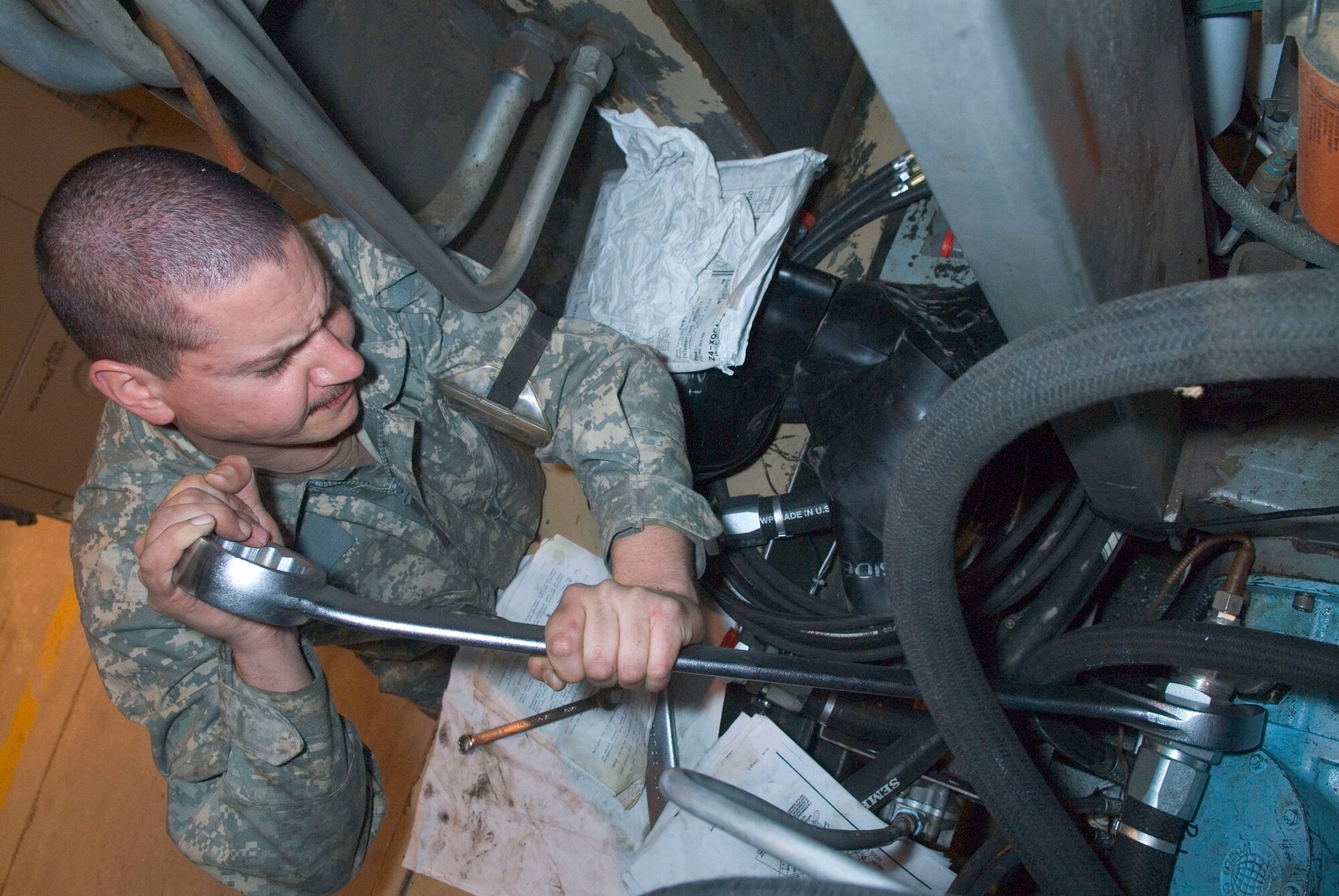 BALAD AIR BASE, Iraq -- Staff Sgt. Bobby Hausermann, a 332nd Expeditionary Maintenance Squadron aircraft ground equipment maintainer, replaces a tube on a hydraulic test stand here, Jan. 5. The hydraulic test stand provides hydraulic pressure for aircraft while they are on ground. Sergeant Hausermann is deployed from Spangdahlem Air Base, Germany. (Air Force photo/Staff Sgt. Joshua Garcia) 