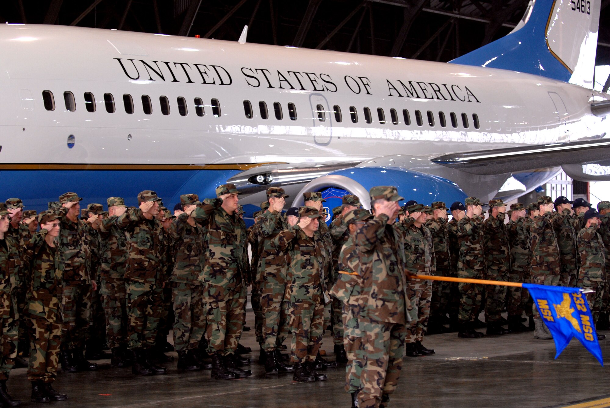 932nd Airlift Wing members salute in front of a C-40C plane at Scott Air Force Base.  Photo/Tech Sgt. Dan Oliver