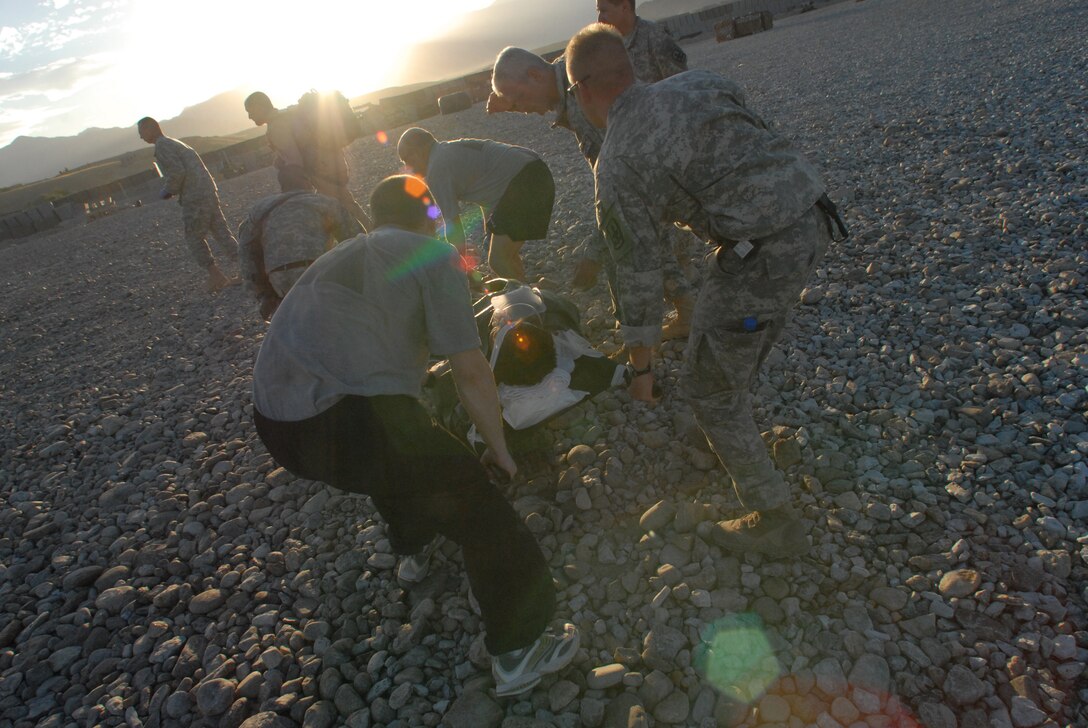 An injured Soldier is transported by Army personnel following a medical evacuation mission in Afghanistan recently. Evacuation missions via helicopter are termed "Dustoff" due to the debris and dirt that end up covering medical technicians due to the helo's rotors. (U.S. Air Force Photo by Tech. Sgt. David Peacock)