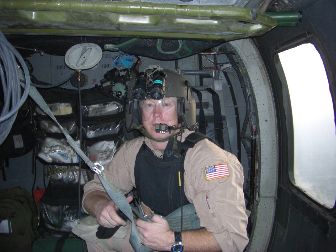 Tech. Sgt. David Peacock, 315th Aeromedial Evacuation Squadron medical technician, prepares to strap in aboard a U.S. Air Force Pavelow Helicopter during a flight over Afghanistan recently. Sergeant Peacock was deployed to Kandahar Airfield as a member of the 33rd Rescue Squadron and participated in "Dustoff" missions there.