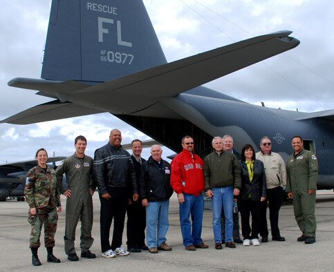 PATRICK AIR FORCE BASE, Fla. -- Mayors and civic leaders from six local towns gathered here Jan. 4 for a tour of the 920th Rescue Wing, which included a flight aboard an HH-60G Pave Hawk helicopter and a tour of an HC-130P/N Hercules aircraft. The 920th provides combat rescue support during wartime, but also has a full-time mission back home, providing launch support for all shuttle and rocket launches from Kennedy Space Center and Cape Canaveral Air Force Station, as well as civilian search-and-rescue support and humanitarian relief. Pictured from left to right are: Capt. Cathleen Snow, 920th public affairs chief; Capt. John Withelder, an HC-130 pilot; Cocoa mayor Michael Blake, Ronald Krueger, chief of police for Melbourne Beach; Ric Holt, city manager for Cocoa who was also a pararescueman in Vietnam; Cocoa Beach mayor Skip Beeler; Cape Canaveral mayor Rocky Randels; Melbourne Beach mayor William Stacey; Kathy Meehan, vice mayor of Melbourne; James Nolan, mayor of Indian Harbour Beach; and Capt. Rafael Benet, who also pilots Hercules aircraft for the wing. (U.S. Air Force photo/Staff Sgt. Paul Flipse)