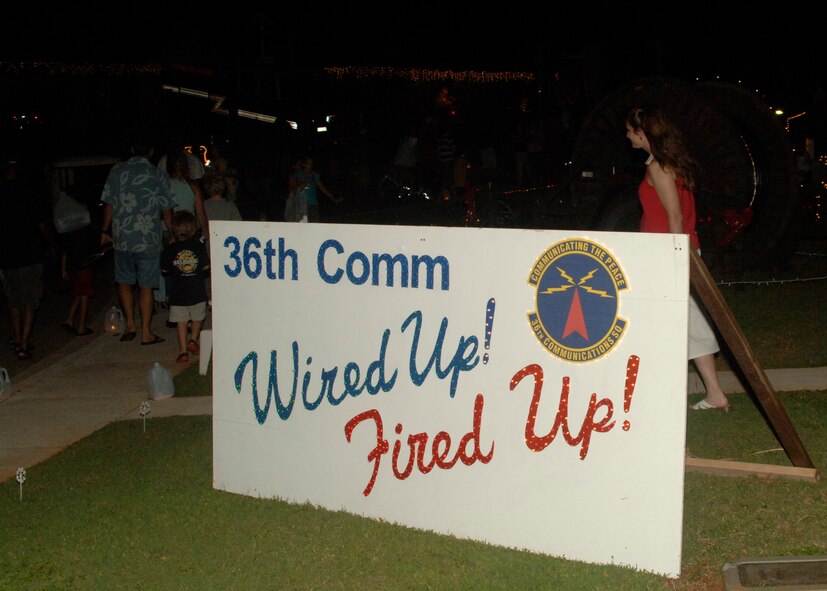 ANDERSEN AIR FORCE BASE, Guam - Lt. Col. Kathleen Grasse walks by her "Wired up, Fired up" Communications cheer during the Rota Walk Dec. 21. (U.S. Air force photo by Airman 1st Class Zachary Hunter)