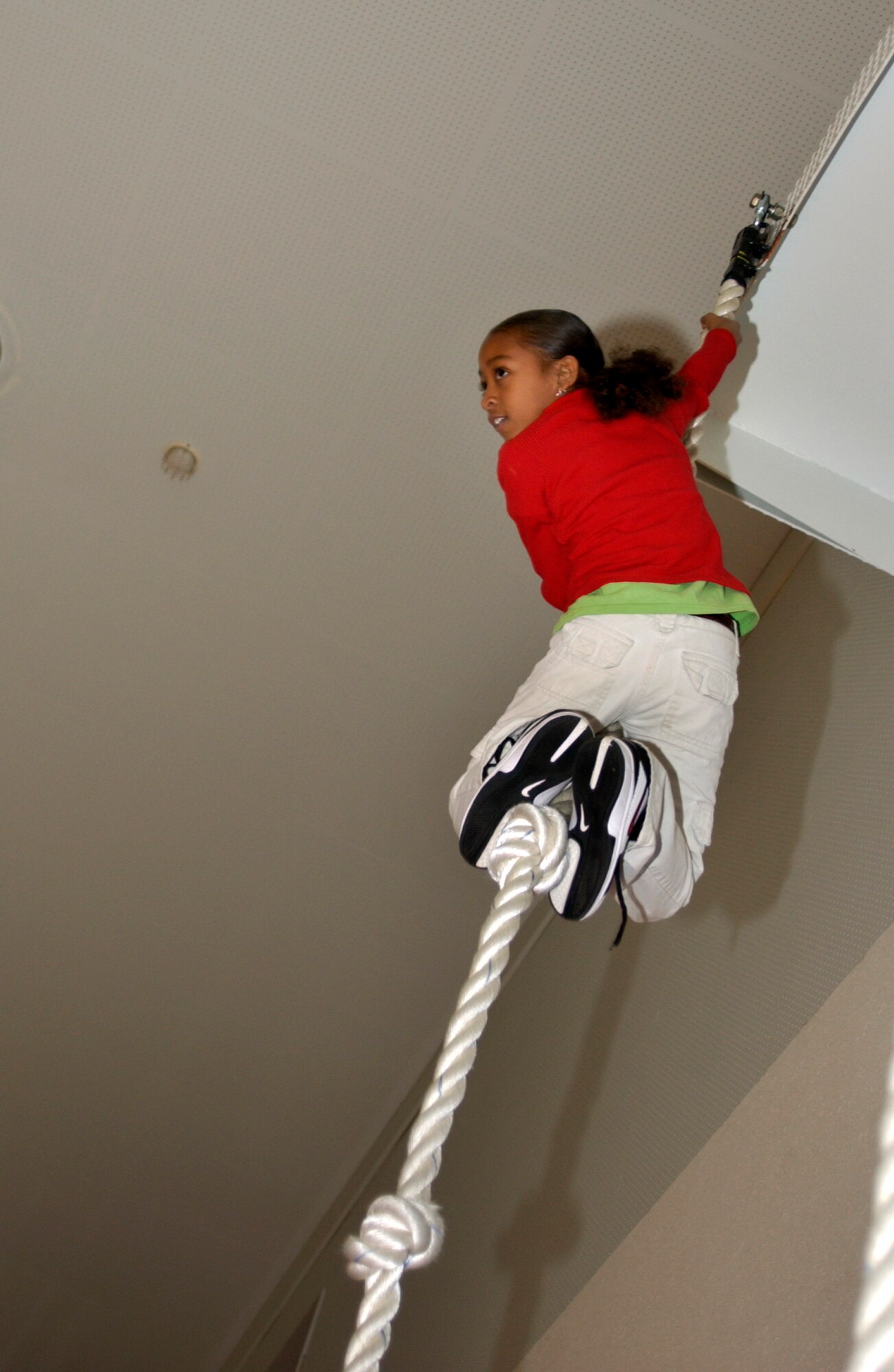 MISAWA AIR BASE, Japan -- Amani Burns, Cummings Elementary, waits at the top of the rope to hear her time after a 3.40 second climb here on Dec 20, 2007. Cummings Elementary challenged first sergeants and the rest of Misawa Air Base to a climbing contest. Amani was the fastest from Cummings and second overall. (US Air Force photo by Airman 1st Class Eric Harris)
