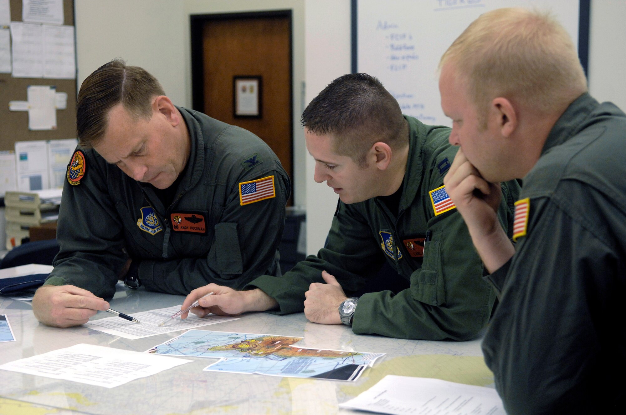 Col. Andy Hockman, Capt. Carl Miller and Staff Sgt. John Eller brief their communication plan Jan. 3 for an upcoming low-level flight at Hickam Air Force Base, Hawaii. Col. Hockman is the 15th Operations Group commander and Capt. Miller and Sgt. Eller are from the 535th Airlift Squadron.In a world of increasingly sophisticated air defenses, the United States needs to maintain a first-class air force. In combat, aircraft often operate at altitudes as low as 100 feet and at high airspeeds to defeat ground missile radars and avoid sophisticated surface-to-air missiles, anti-aircraft artillery, and enemy fighters. (U.S. Air Force photo/Tech. Sgt. Shane A. Cuomo) 