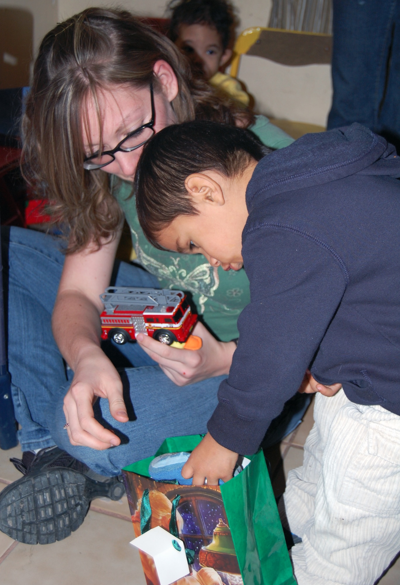 LAUGHLIN AIR FORCE BASE, Texas – Airman 1st Class Nichole Boardman, 47th Comptroller Squadron, becomes acquainted with children from Casa de Hogar Manantial de Amor Orphanage, Ciudad Acuña, Mexico during a recent visit from a couple Laughlin members and a  group from Ruben Chavira Elementary School.(U.S. Air Force photo by Airman 1st Class Sara Csurilla)



