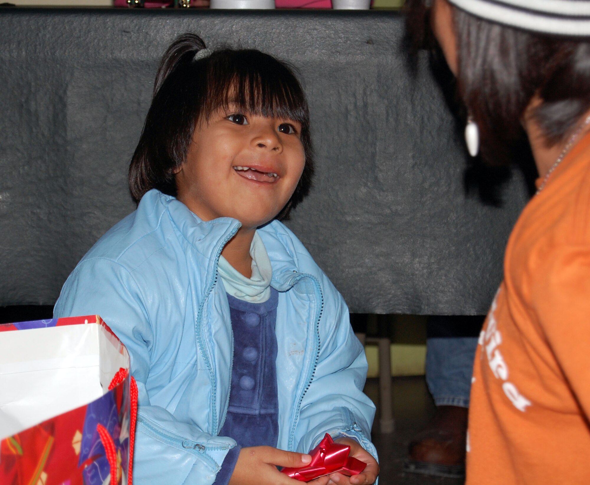 LAUGHLIN AIR FORCE BASE, Texas –A young girl in the Casa de Hogar Manantial de Amor Orphanage, Ciudad Acuña, Mexico opens her Christmas gift during a recent visit from a couple Laughlin members and a  group from Ruben Chavira Elementary School recently. The trip to the orphanage was to try and help less fortunate children receive gifts and good company during the Holiday Season.(U.S. Air Force photo by Airman 1st Class Sara Csurilla)

