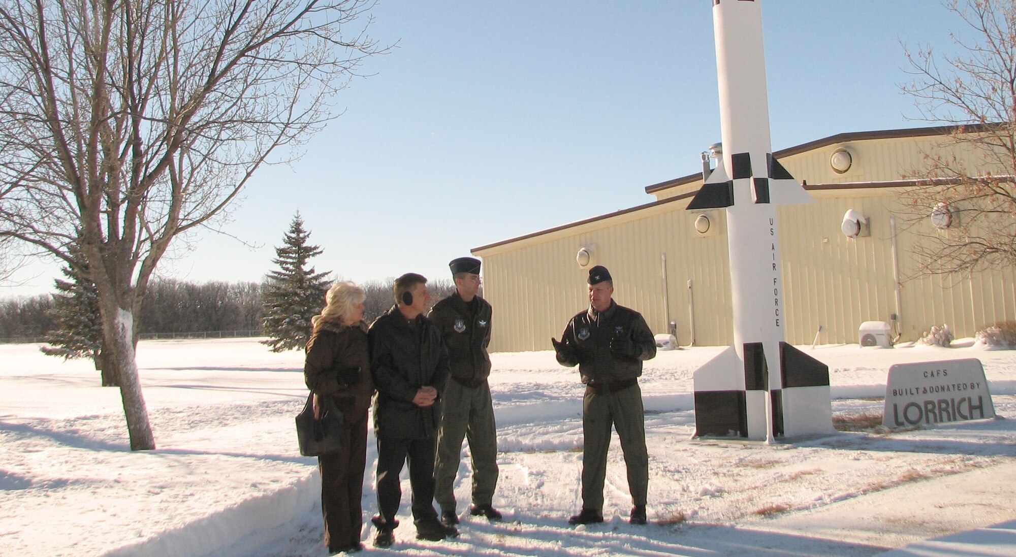Col. Chris Crawford, 21st Operations Group commander (right), addresses Lt. Col. Keith Balts and others during a Spartan missile dedication at Cavalier AFS, N.D. The missile, one of America’s earliest forms of missile defense, was donated to the air force station by local company Lorrich Industries. Colonel Balts is the 10th Space Warning Squadron commander there. (U.S. Air Force photo/Capt. Michael Stayrook)