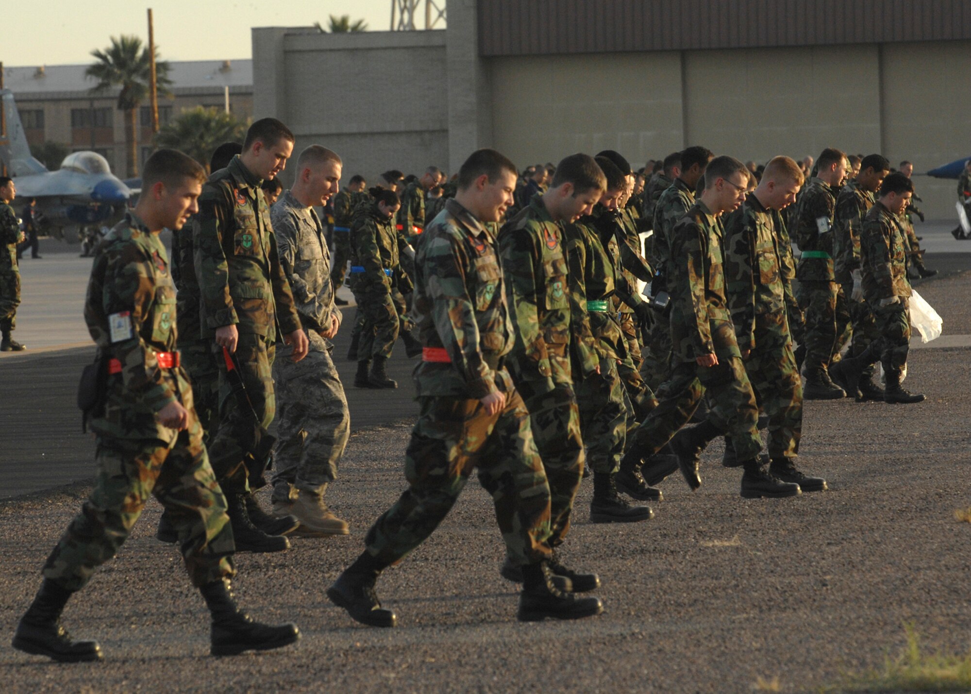 Members of the 56th Fighter Wing perform the annual wing foreign object damage walk here on 3 Jan. FOD detection saves the air force millions of dollars each year in extra parts and unscheduled maintenance. (photo by Tech. Sgt. Raheem Moore)