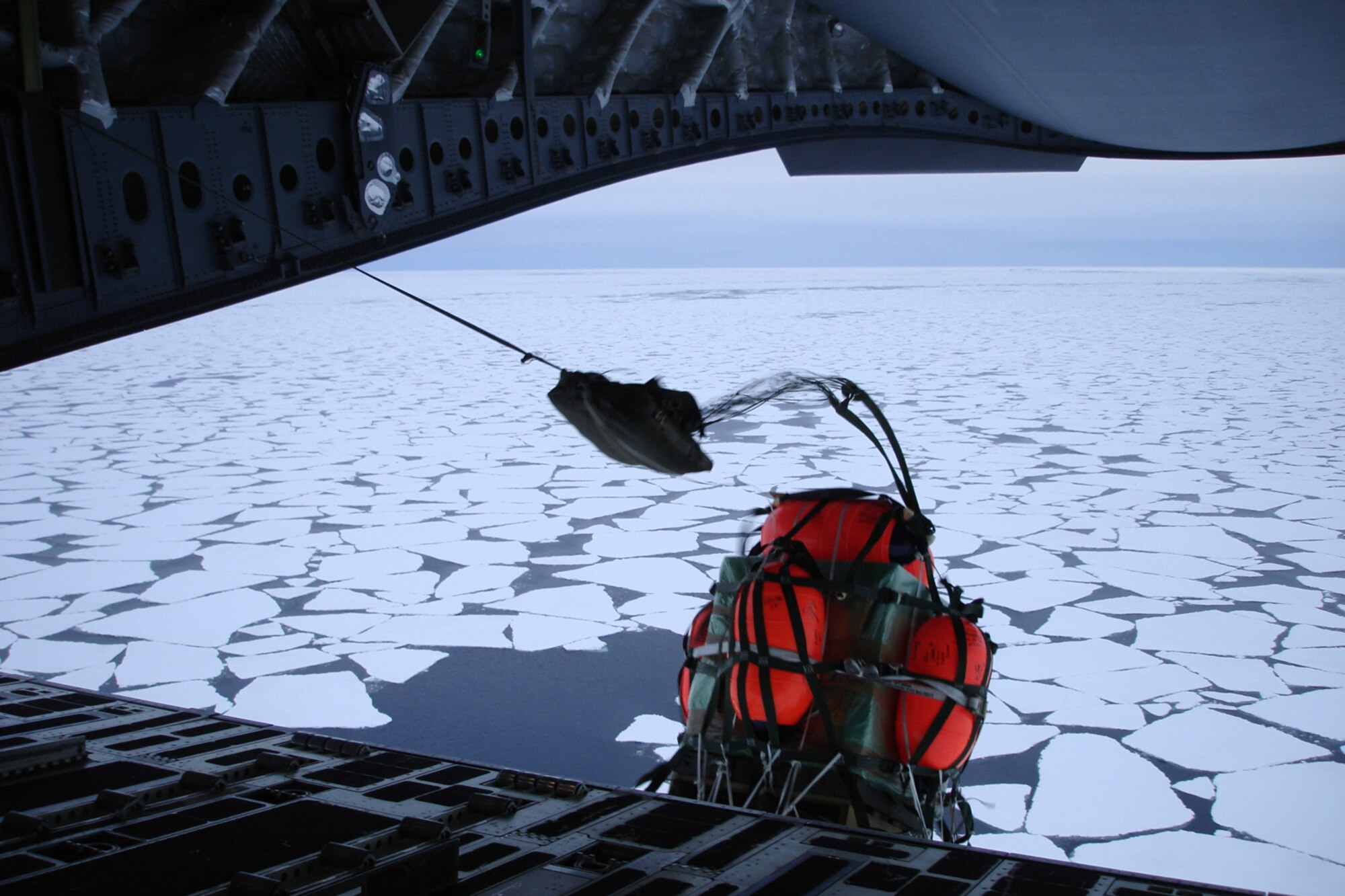 Palletized cargo is airdropped from a C-17 Jan. 5 by a crew of Reserve and active-duty Airmen from McChord Air Force Base, Wash. The C-17 drop delivered a new engine and supplies to a stranded British fishing trawler in the Antarctic. (U.S. Air Force photo)                    