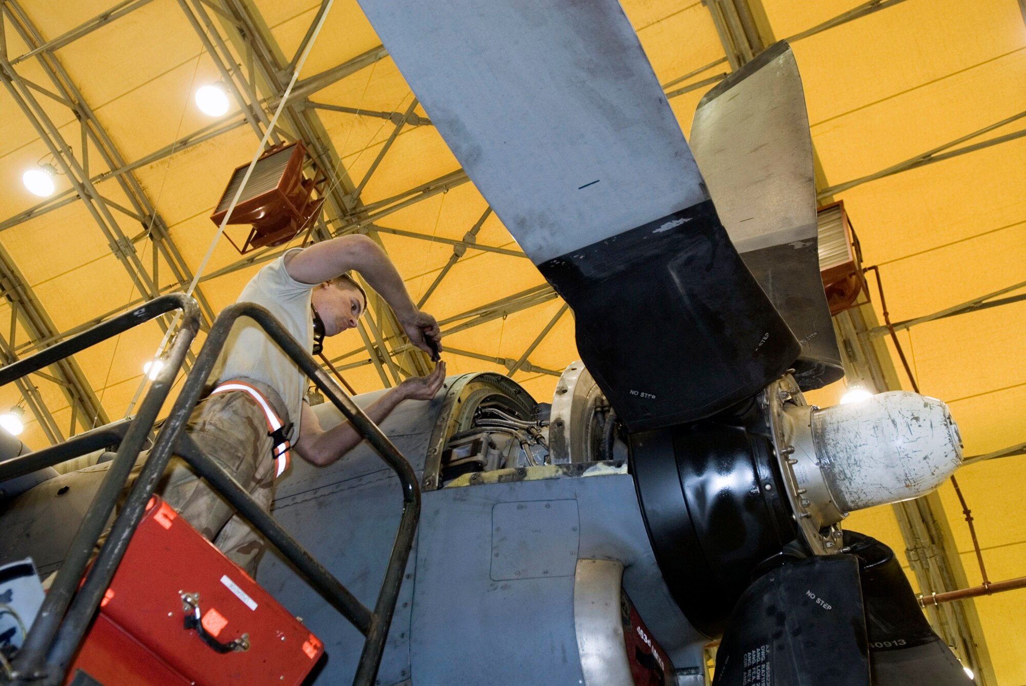 Airman 1st Class Devon Loftis closes the engine hatch of a C-130 Hercules after lubricating engine components during a 90-day engine inspection Jan. 4 at Balad Air Base, Iraq. Engines on the aircraft are thoroughly checked and replenished with fluids during the inspections. Airman Loftis is an aircraft maintenance unit crew chief for the 777th Expeditionary Airlift Squadron and is deployed from F.E. Warren Air Force Base, Wyo. (Air Force photo/Staff Sgt. Joshua Garcia) 
