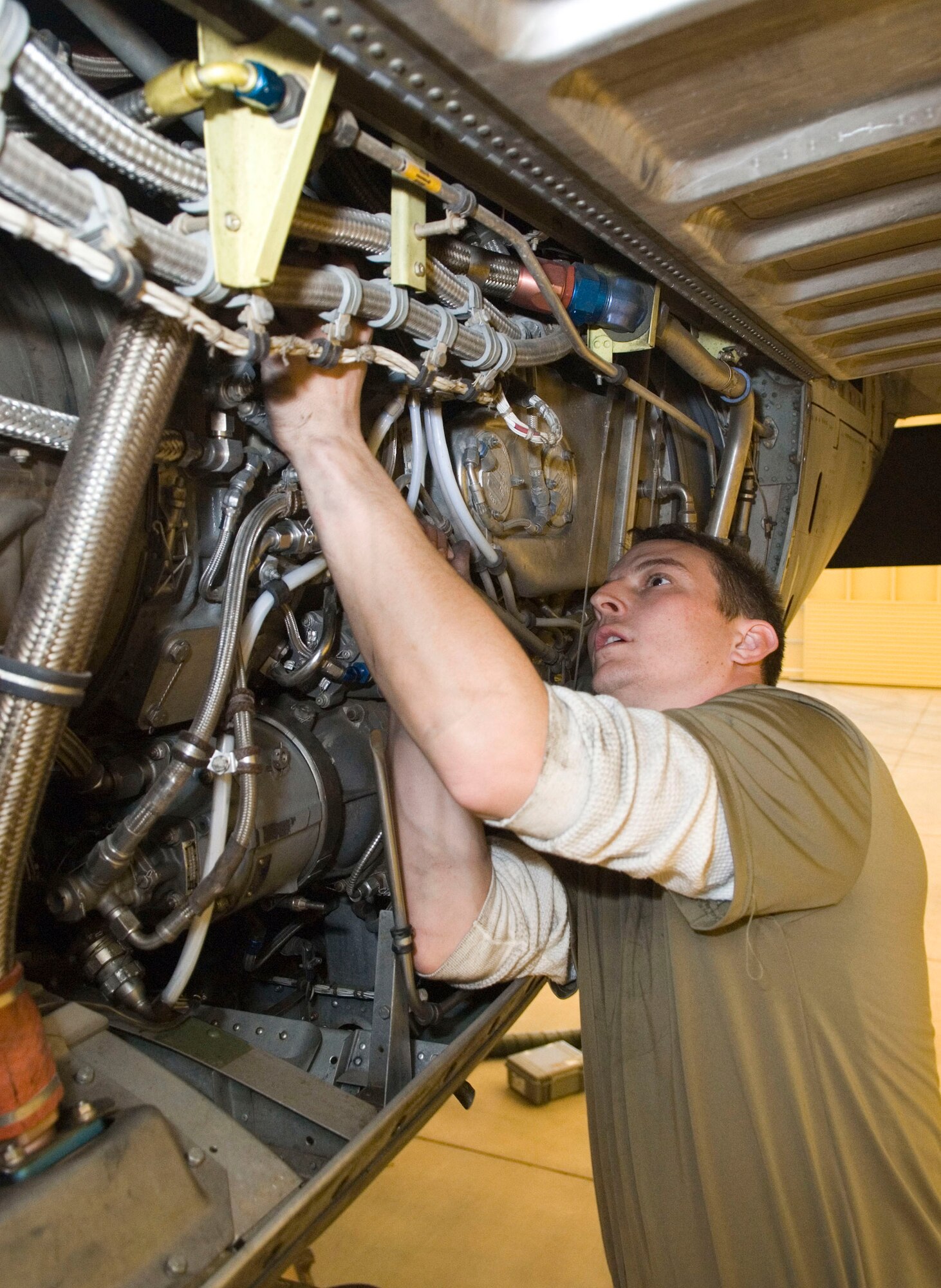 Senior Airman Wes Leturgez checks for discrepancies on a C-130 Hercules engine Jan. 4  while performing a 90-day inspection on the engine at Balad Air Base, Iraq. Airman Leturgez is an aircraft maintenance unit crew chief for the 777th Expeditionary Airlift Squadron and is deployed from Little Rock Air Force Base, Ark. (Air Force photo/Staff Sgt. Joshua Garcia) 