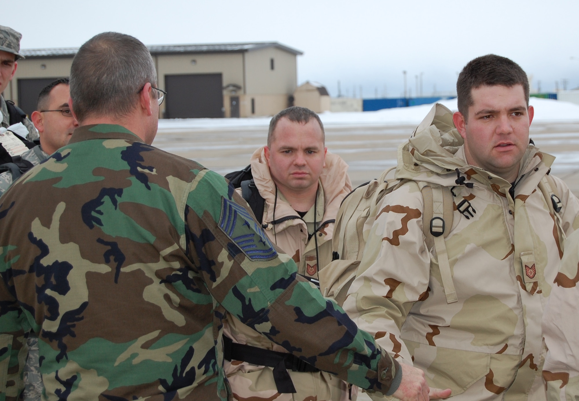 Chief Master Sgt. Ken Czop, 388th command chief master sergeant, shakes hands with 421st Fighter Squadron Airmen as they deploy in support of Operation Iraqi Freedom.  During their time in the Central Command area of operations, the squadron will maintain security and stability in the region by providing close air support to coalition ground forces.  (U.S. Air Force photo by Ralph Jackson)