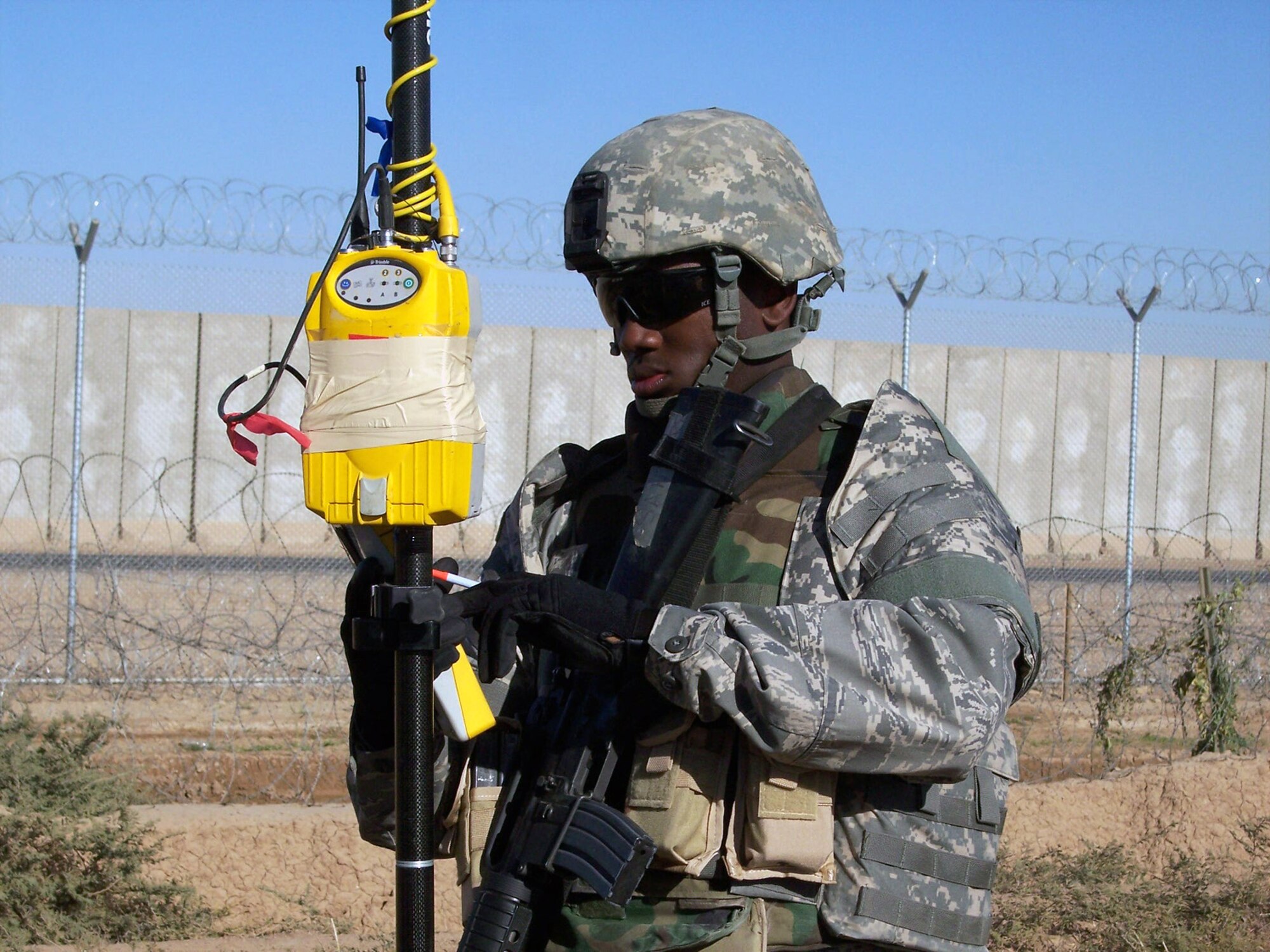Senior Airman Renardo Sanders conducts a topographical survey Jan. 7 of the levee just outside of the perimeter fence on the west side of Balad Air Base, Iraq. The data collected is used by the levee repair team in stopping base flooding and to provide 500,000 gallons of water to Iraqi farm land. Airman Sanders is a 732nd Expeditionary Civil Engineering Squadron engineering assistant, deployed from Beale Air Force Base, Calif. (U.S. Air Force photo/Capt. Christopher Mercer) 