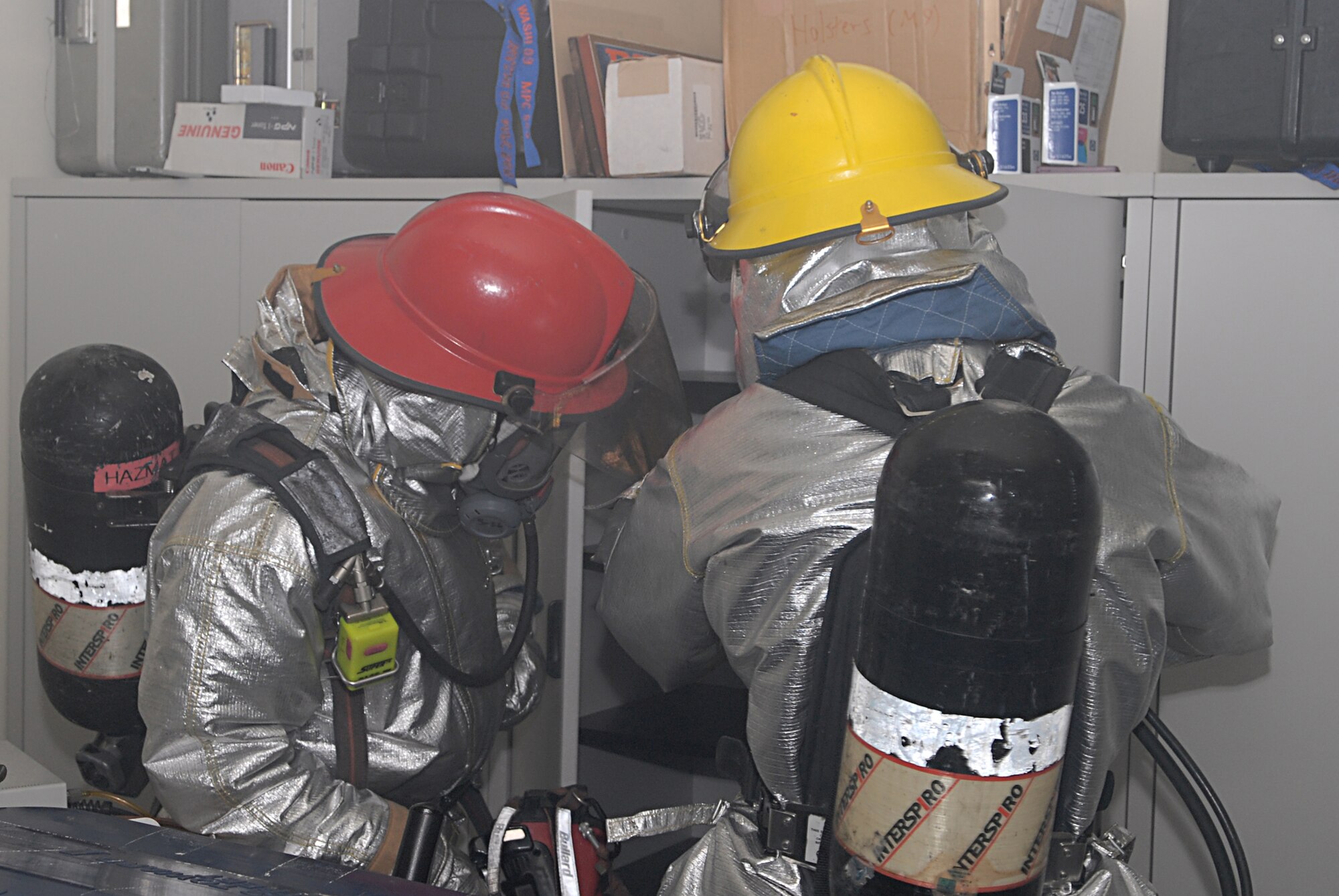 Firefighters assigned to the 18th Civil Engineer Group search through all the rooms of Bldg. 3529 after responding to a fire and bug out scenario at the 961st Airborne Air Control Squadron during Local Operational Readiness Exercise Beverly High 08-3 at Kadena Air Base, Japan, Jan. 7, 2007. The 18th Wing conducted the exercise from Jan. 7 to 11 to test the wing's ability to respond in contingency situations.              (U.S. Air Force photo/Staff Sgt. Chrissy FitzGerald)