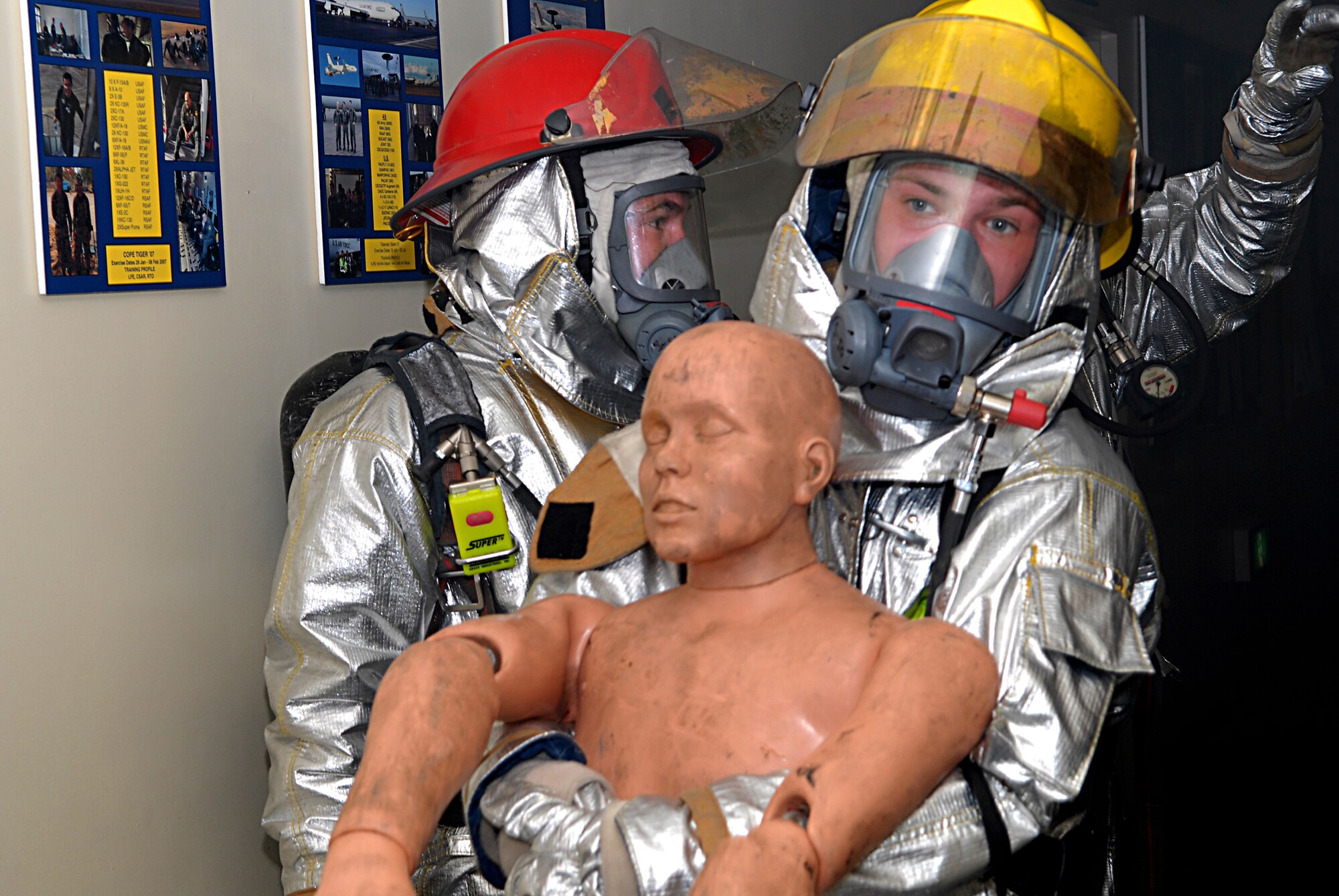 A firefighter assigned to the 18th Civil Engineer Group carries out a victim of a  fire and bug out scenario at the 961st Airborne Air Control Squadron during Local Operational Readiness Exercise Beverly High 08-3 at Kadena Air Base, Japan, Jan. 7, 2007. The 18th Wing conducted the exercise from Jan. 7 to 11 to test the wing's ability to respond in contingency situations. 
(U.S. Air Force photo/Staff Sgt. Chrissy FitzGerald)