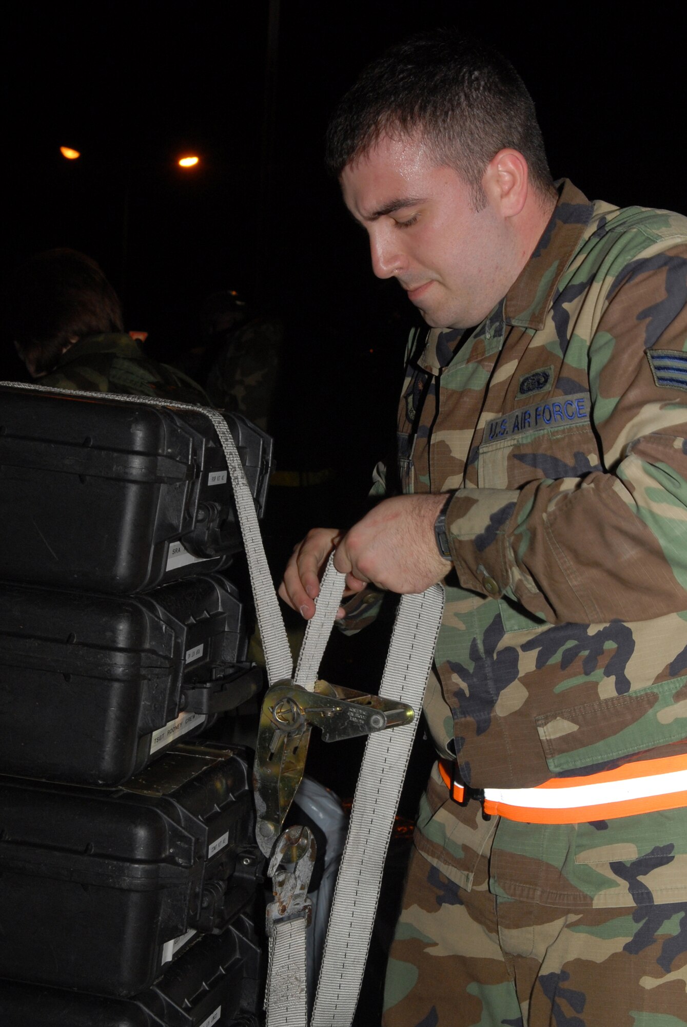 Senior Airman Aaron Szumiesz, 961st Airborne Air Control Squadron, secures equipment for safe transport to another location, due to a fire and bug out scenario in Bldg. 3529, during Local Operational Readiness Exercise Beverly High 08-3 at Kadena Air Base, Japan, Jan. 7, 2007. The 18th Wing conducted a LORE from Jan. 7 to 11 to test the wing's ability to respond in contingency situations.                        (U.S. Air Force photo/Staff Sgt. Chrissy FitzGerald)