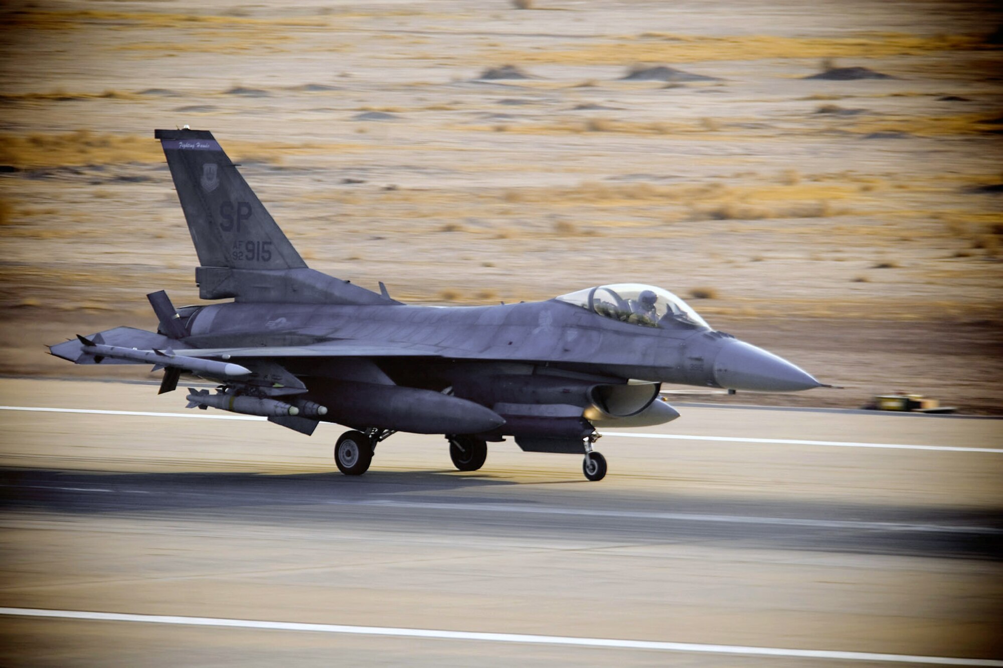 An F-16 Fighting Falcon from the 22nd Expeditionary Fighter Squadron lands at Balad Air Base, Iraq. Members of the 22nd EFS, deployed from Spangdahlem AB, Germany, fly missions daily in support of Operation Iraqi Freedom. (U.S. Air Force photo/Master Sgt. John Nimmo Sr.)